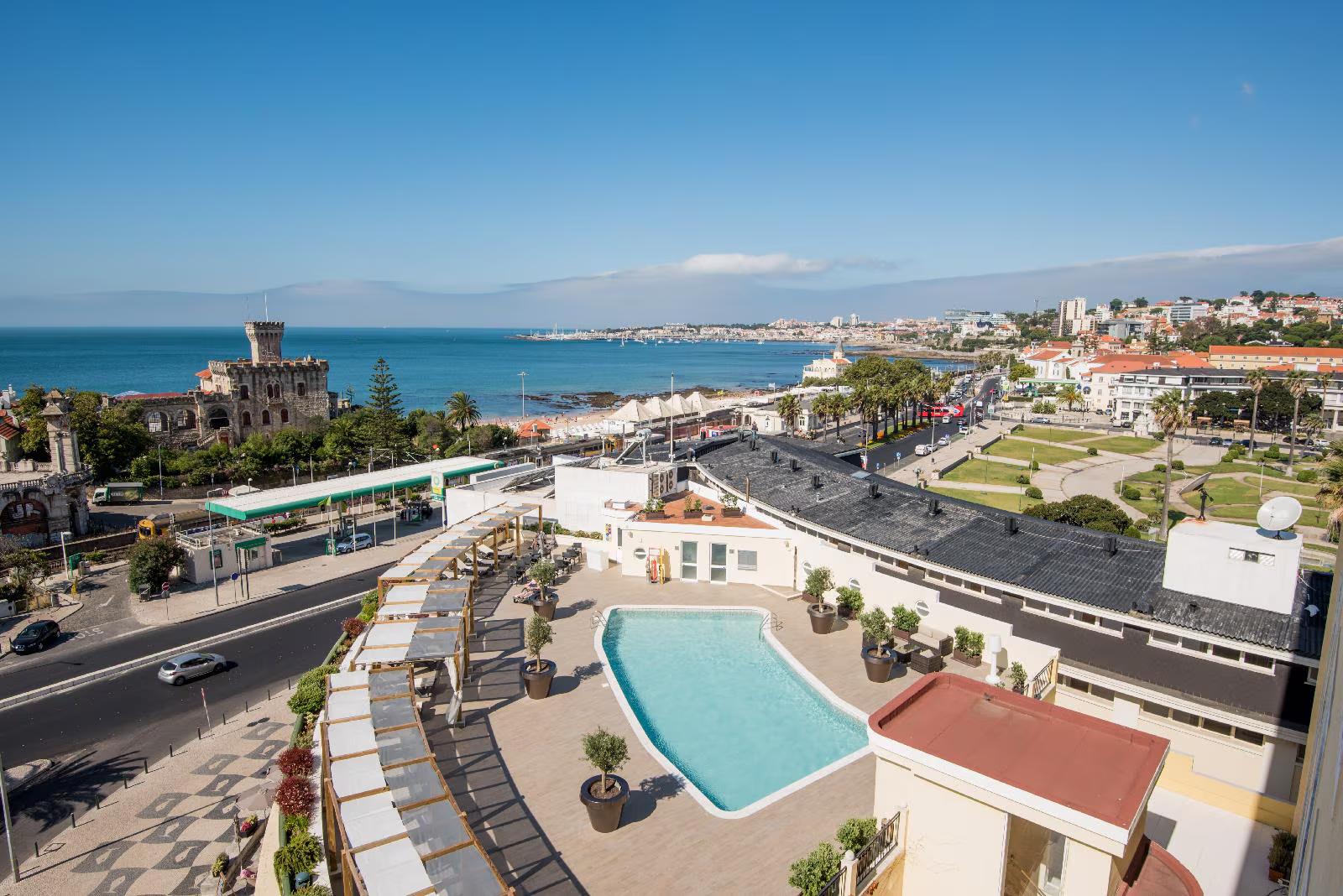 Aerial view of the rooftop swimming pool area and the bay in the background