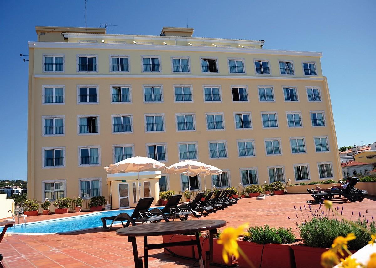 Outdoor swimming pool area overlooked by the hotel