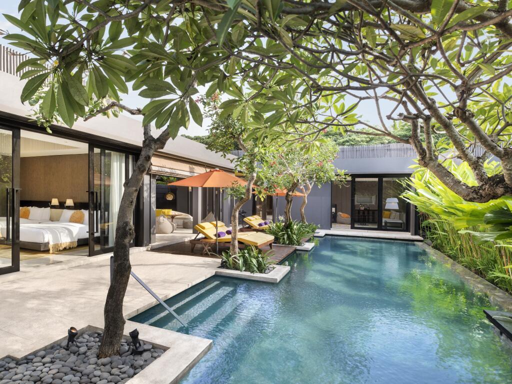 Outdoor swimming pool in the garden or guests suites nestled with trees