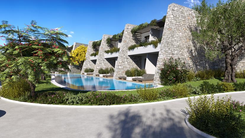 A shared swimming pool for neighbouring villas equipped with two sun beds per