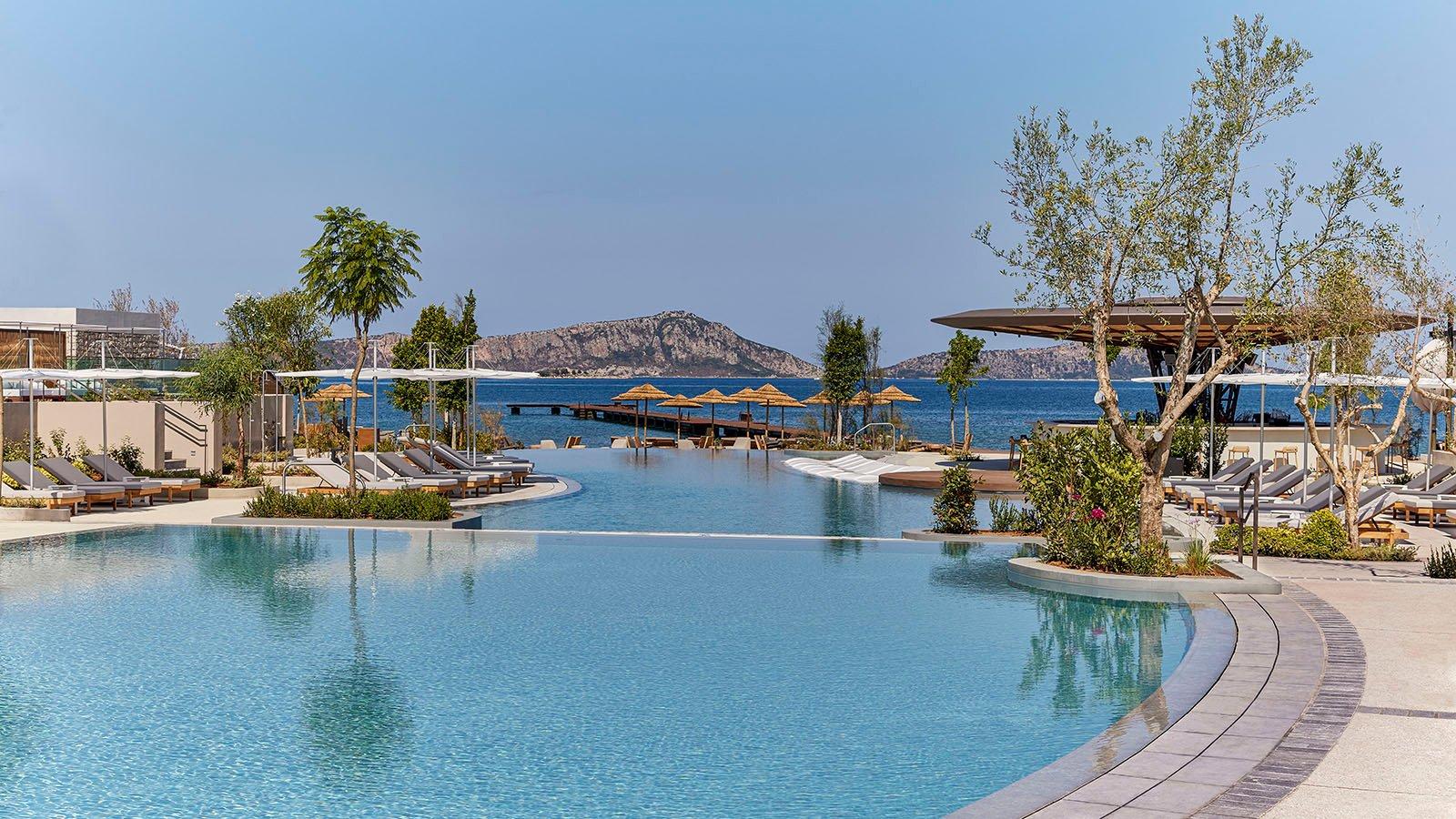 An outdoor swimming pool at the W Hotel Costa Navarino with sea and mountain views