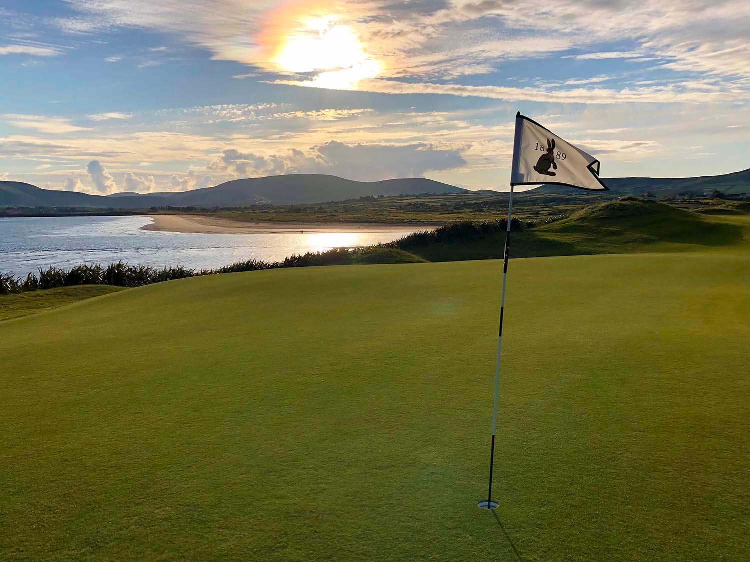 Close view of the sun overlooking well kept greens at Waterville Links