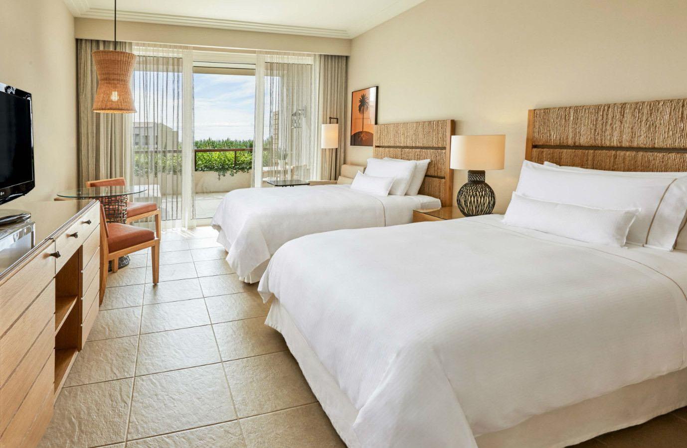 Twin double bed room at the hotel with balcony views