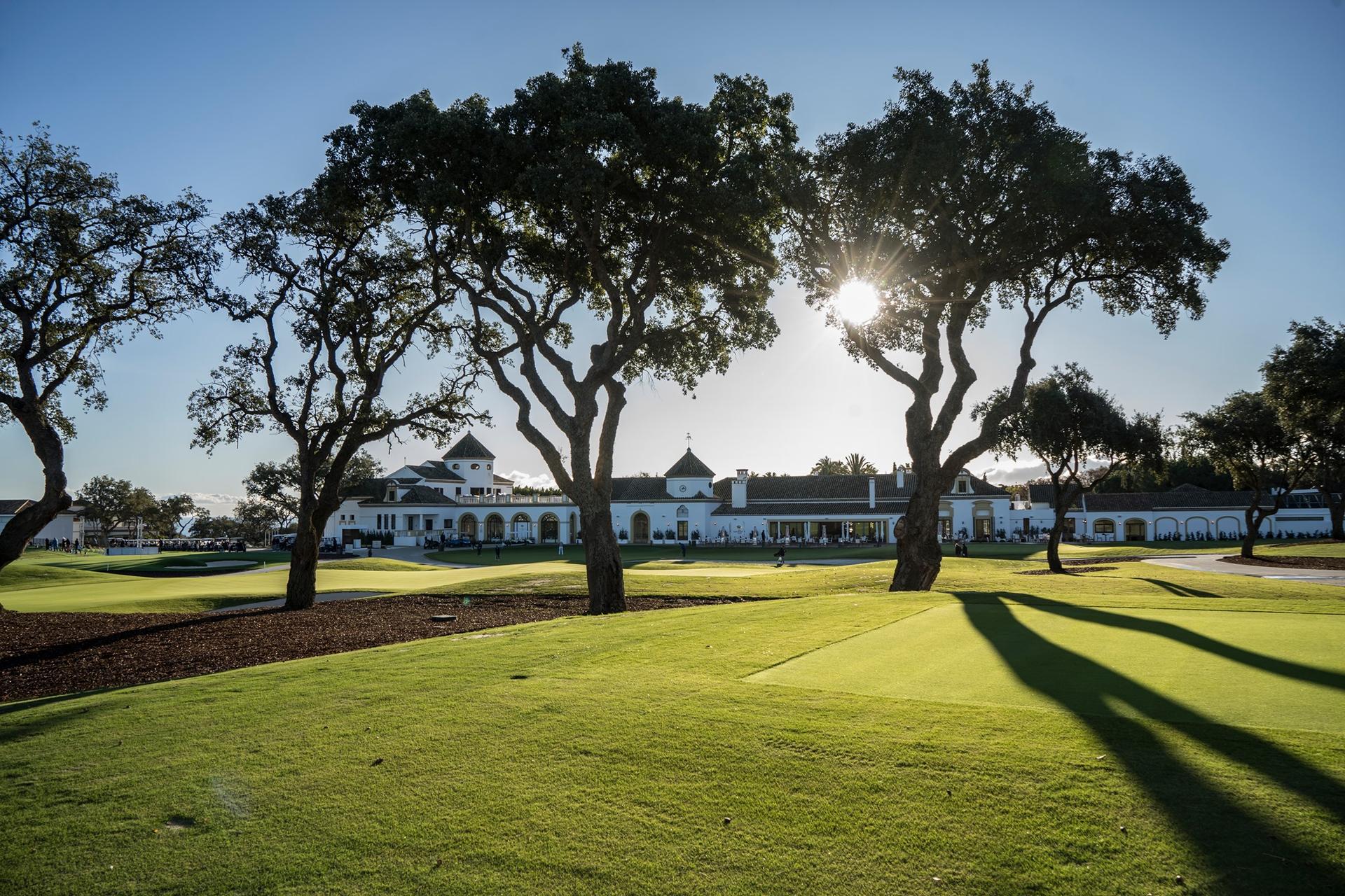 Sun shining down on the clubhouse building looking over the course