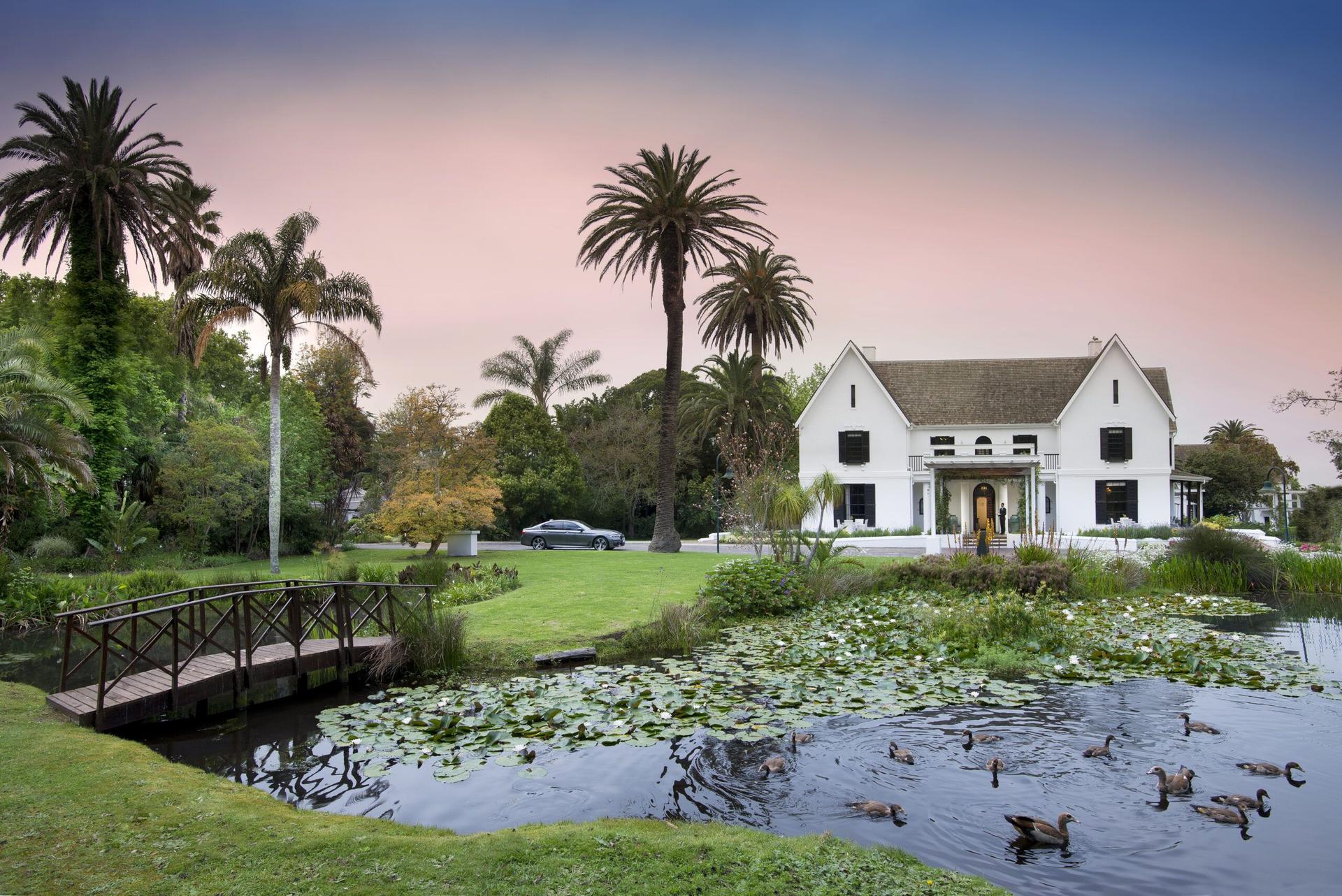 Outdoor view of Fancourt Hotel & Manor House with a pond in front