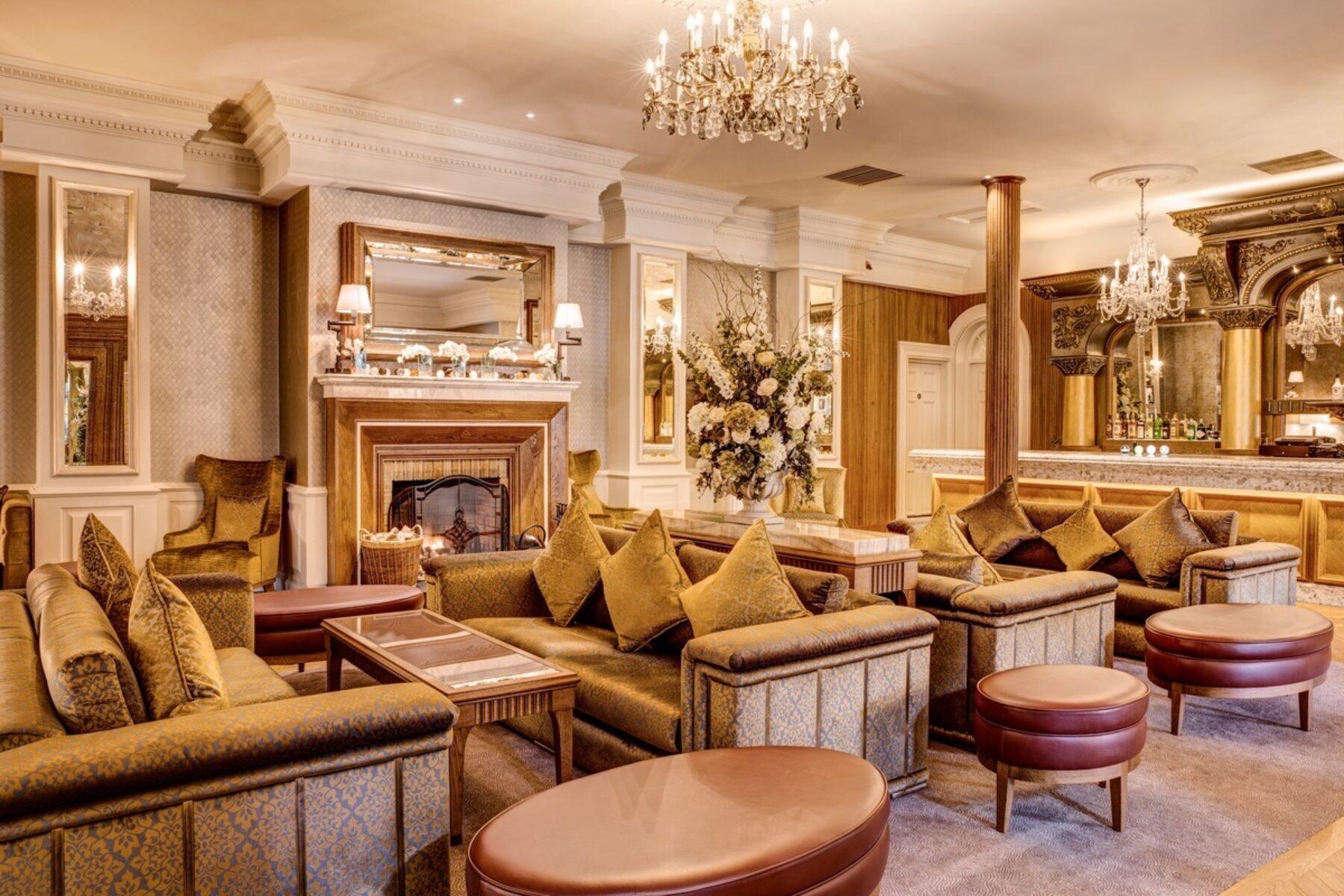 A luxurious indoor lounging area with a grand chandler at Galgorm Resort