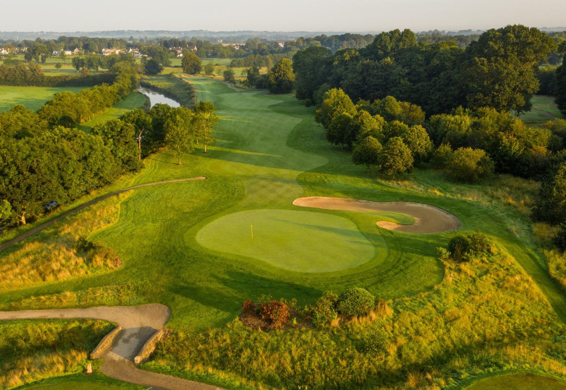 Overhead view of a smooth green surrounded by sand bunkers
