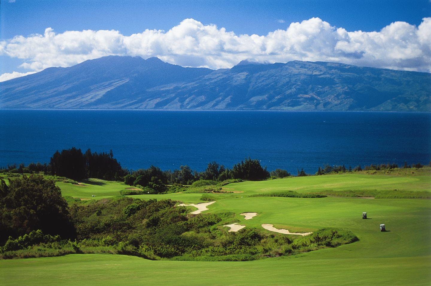Winding fairway with sea views and a volcano in the background