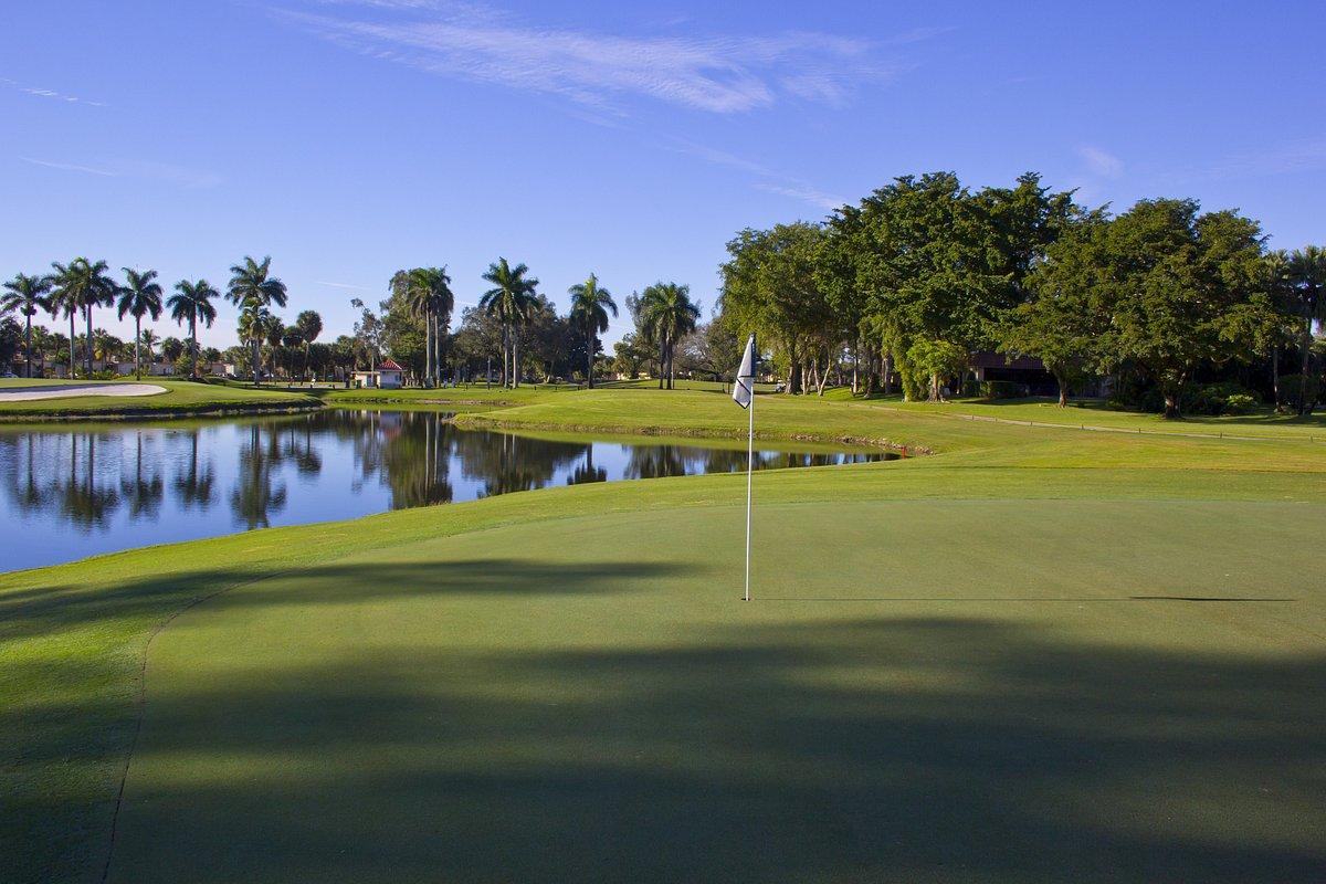 Miami Lakes golf course green with a lake in the background