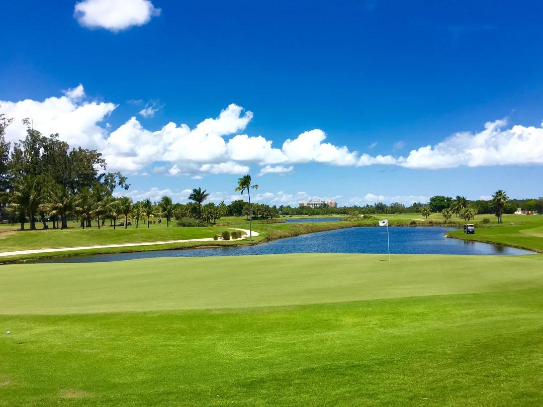 Golf course green with a lake in the background