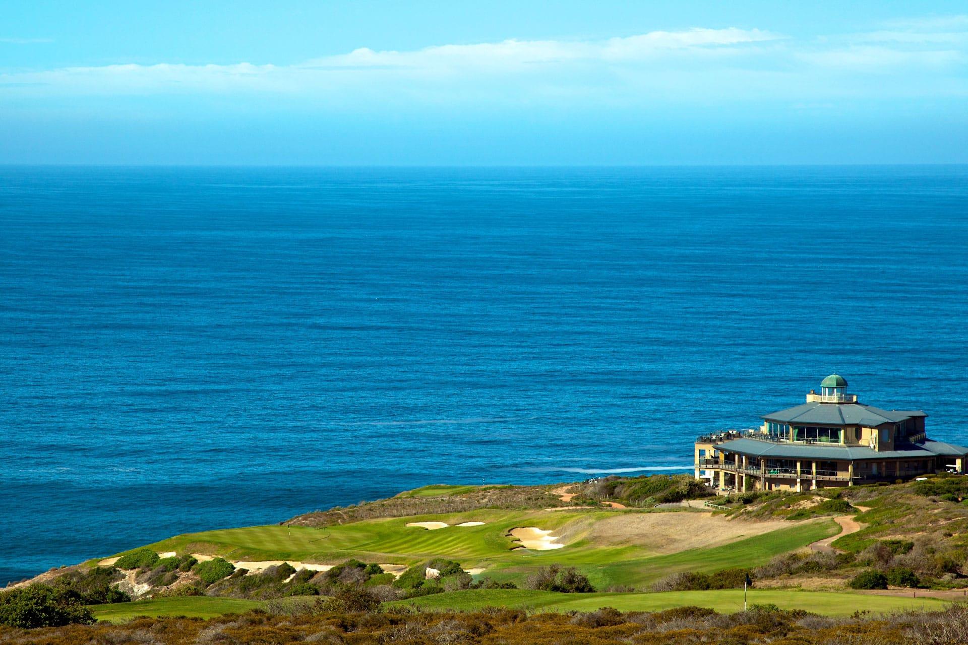 Aerial view of Pinnacle Point's clubhouse with sea views in the background