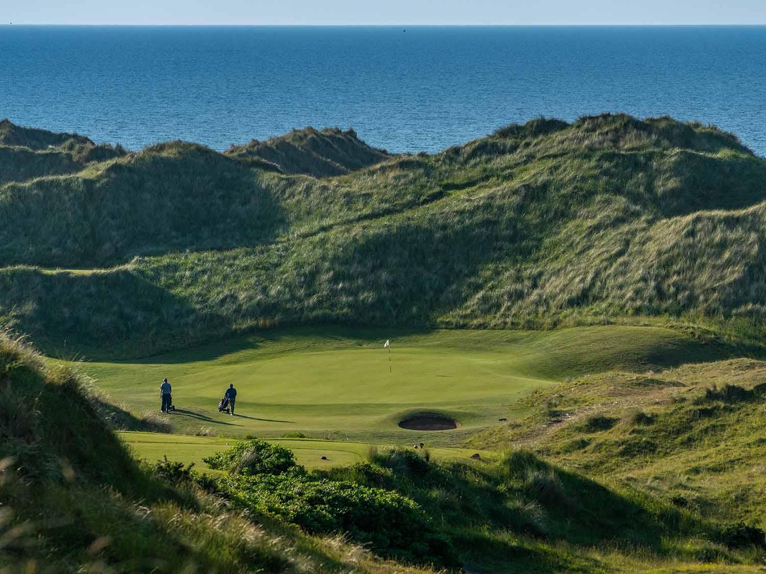 Portstewart Golf Club fairway running along rugged Irish coastline
