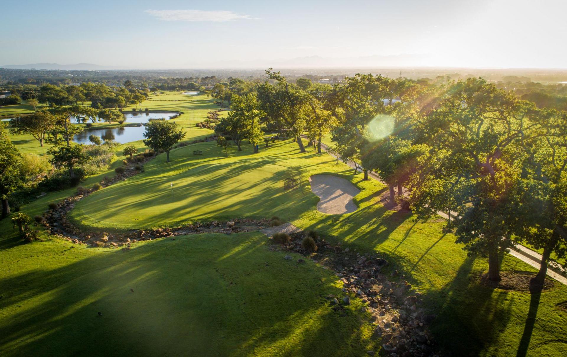Aerial view of Steenberg Golf Club, showing tree-lined fairways and perilous water hazards