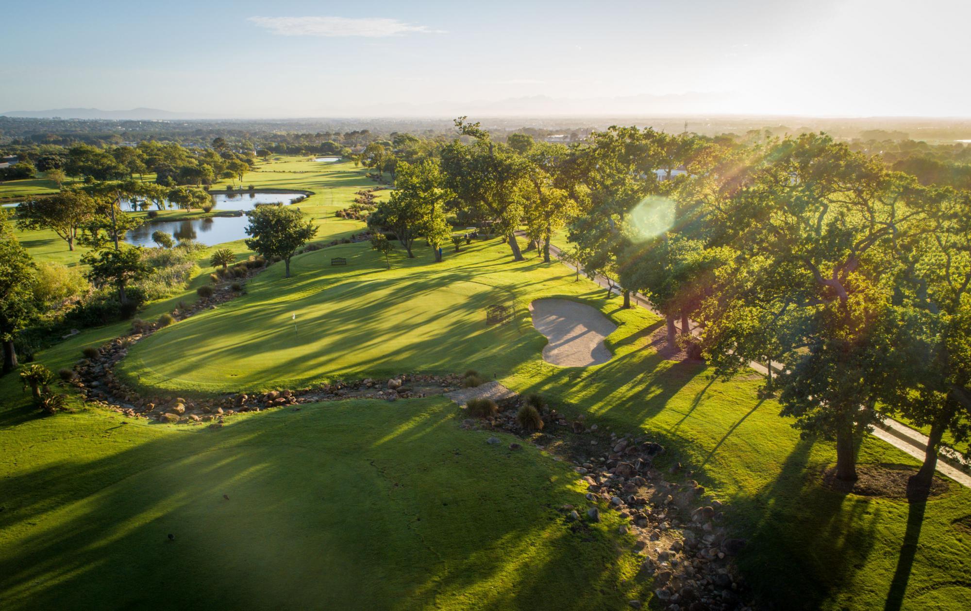 Aerial view of Steenberg Golf Club, showing tree-lined fairways and perilous water hazards