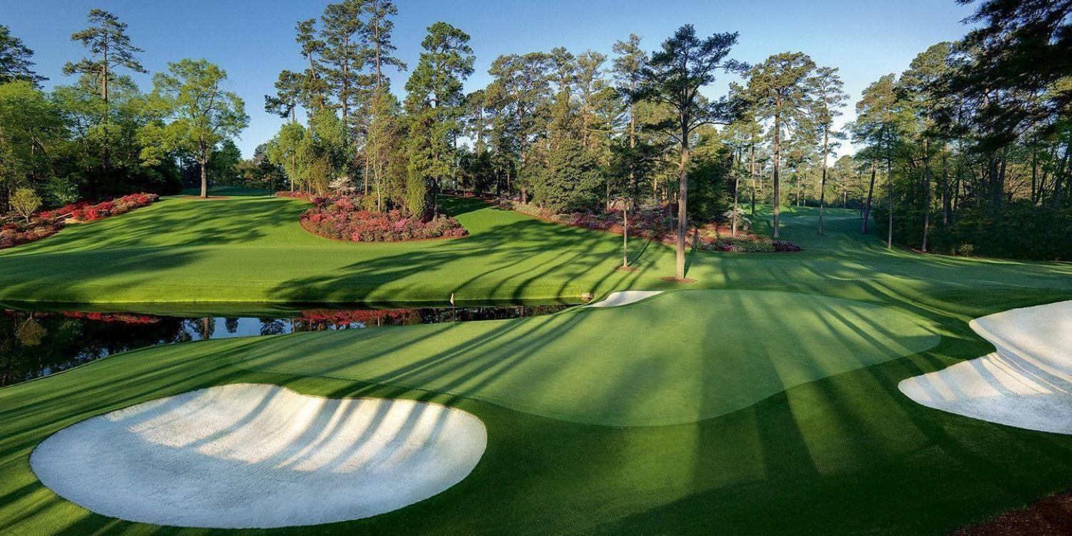 Augusta National green with bunkers around and a water hazard in front