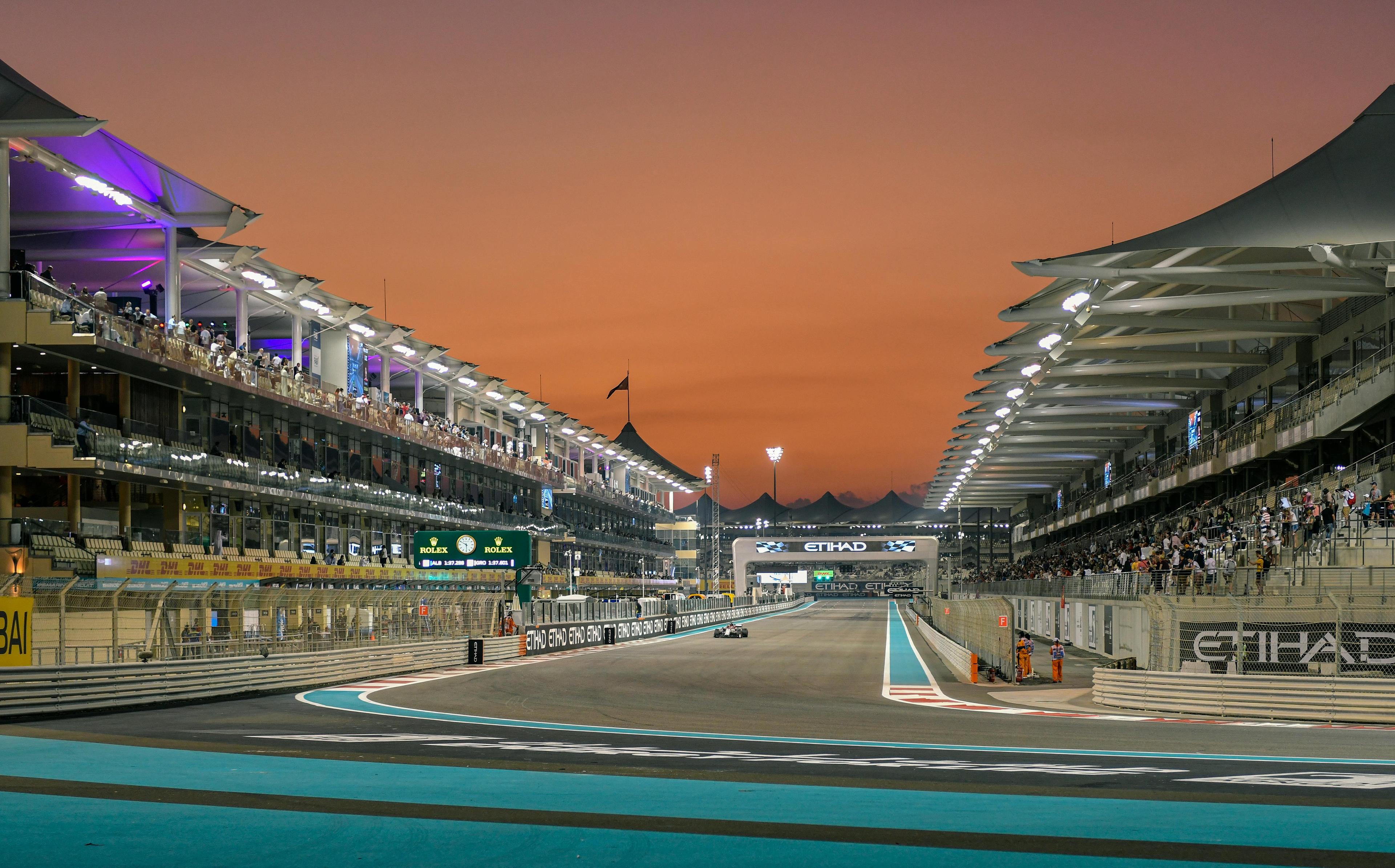 Main straight at Yas Marina Circuit with the sunset in the background