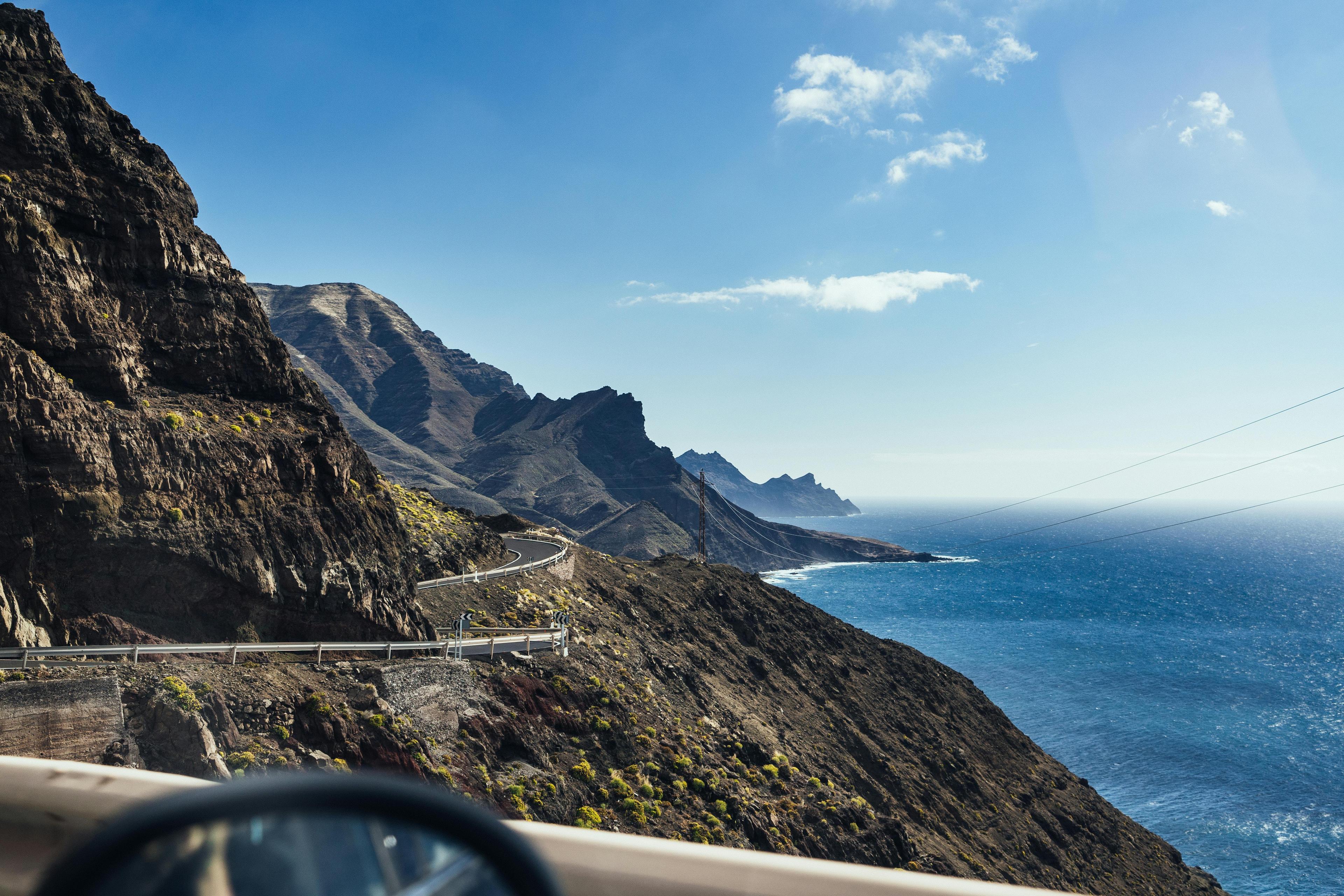 Windy road in the mountains with the sea in the background