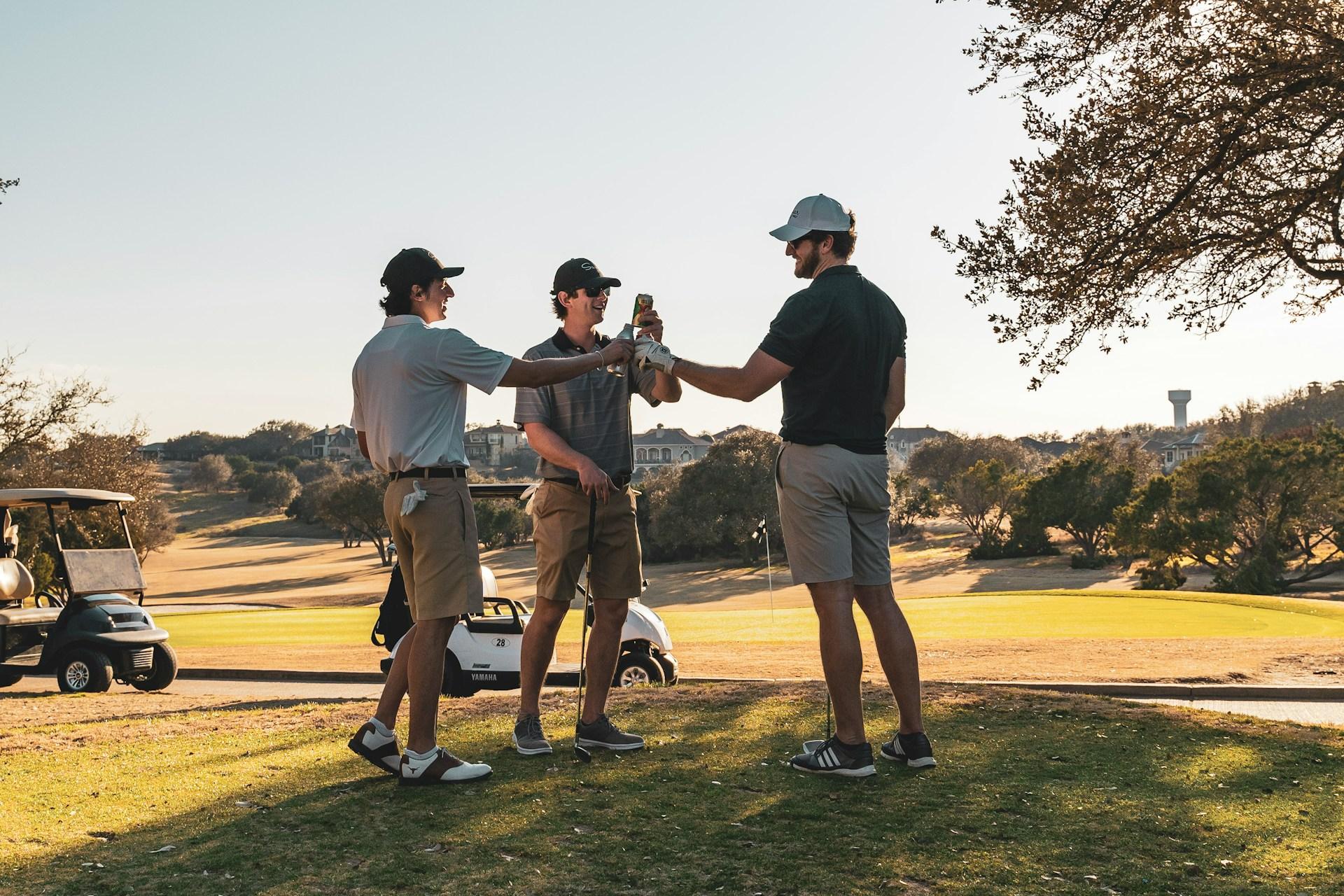 group of golfers drinking a beer in the golf course
