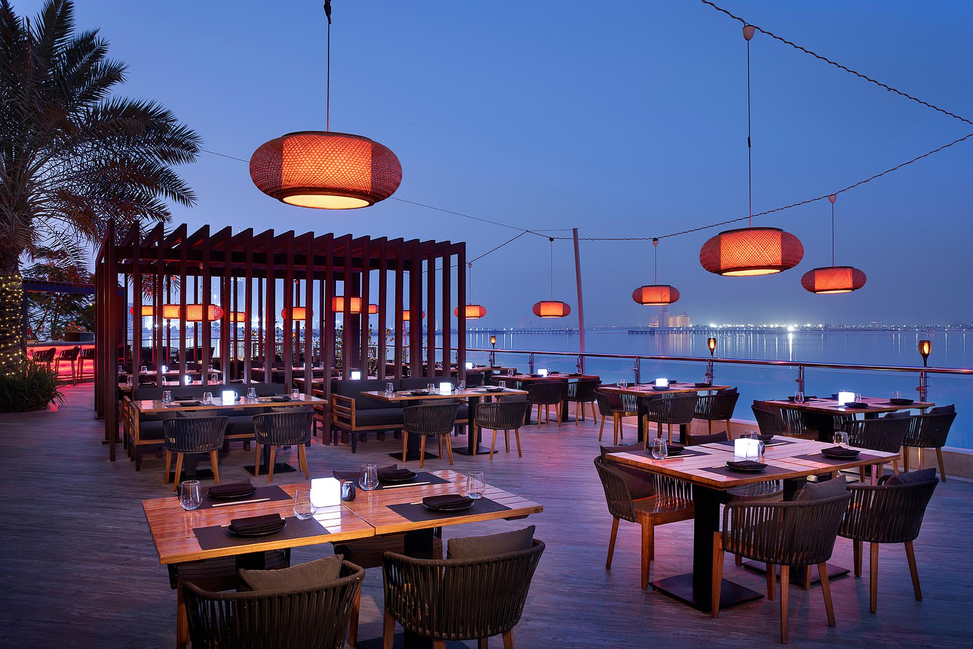 Outdoor dining area with sea views in the evening