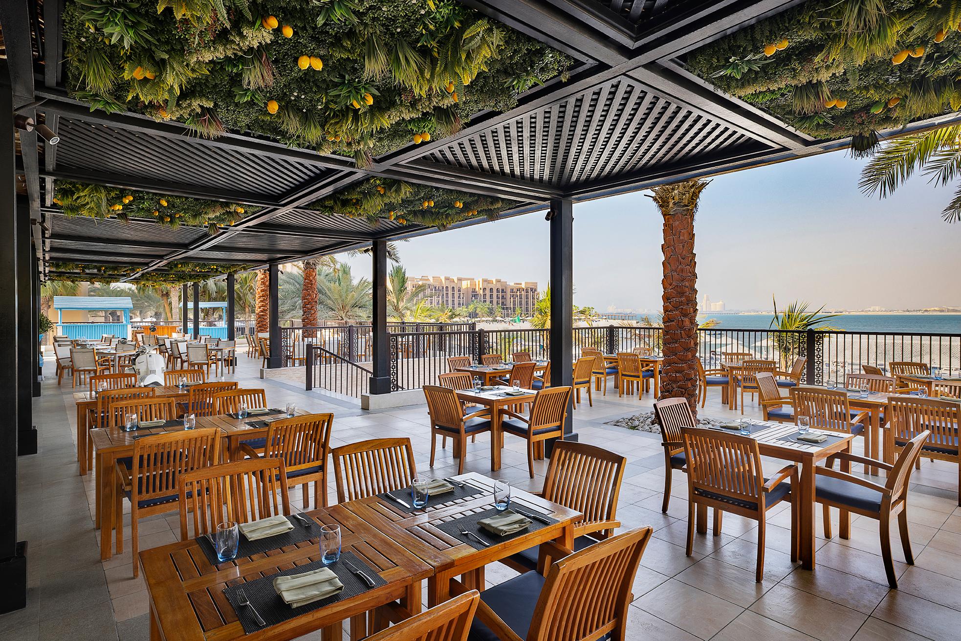Outdoor balcony dining area with beach and sea views