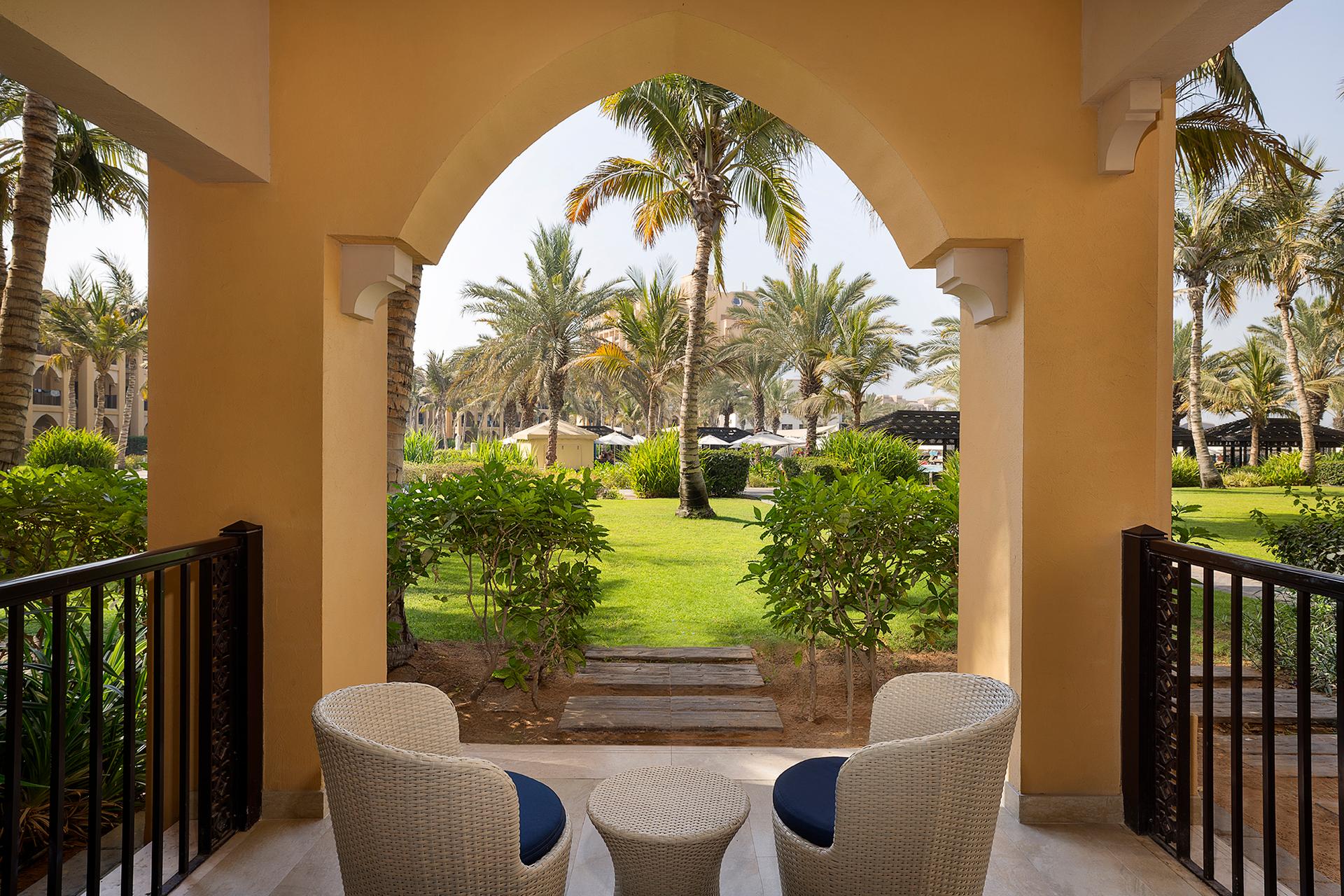 Outdoor patio area with furniture overlooking the hotel grounds