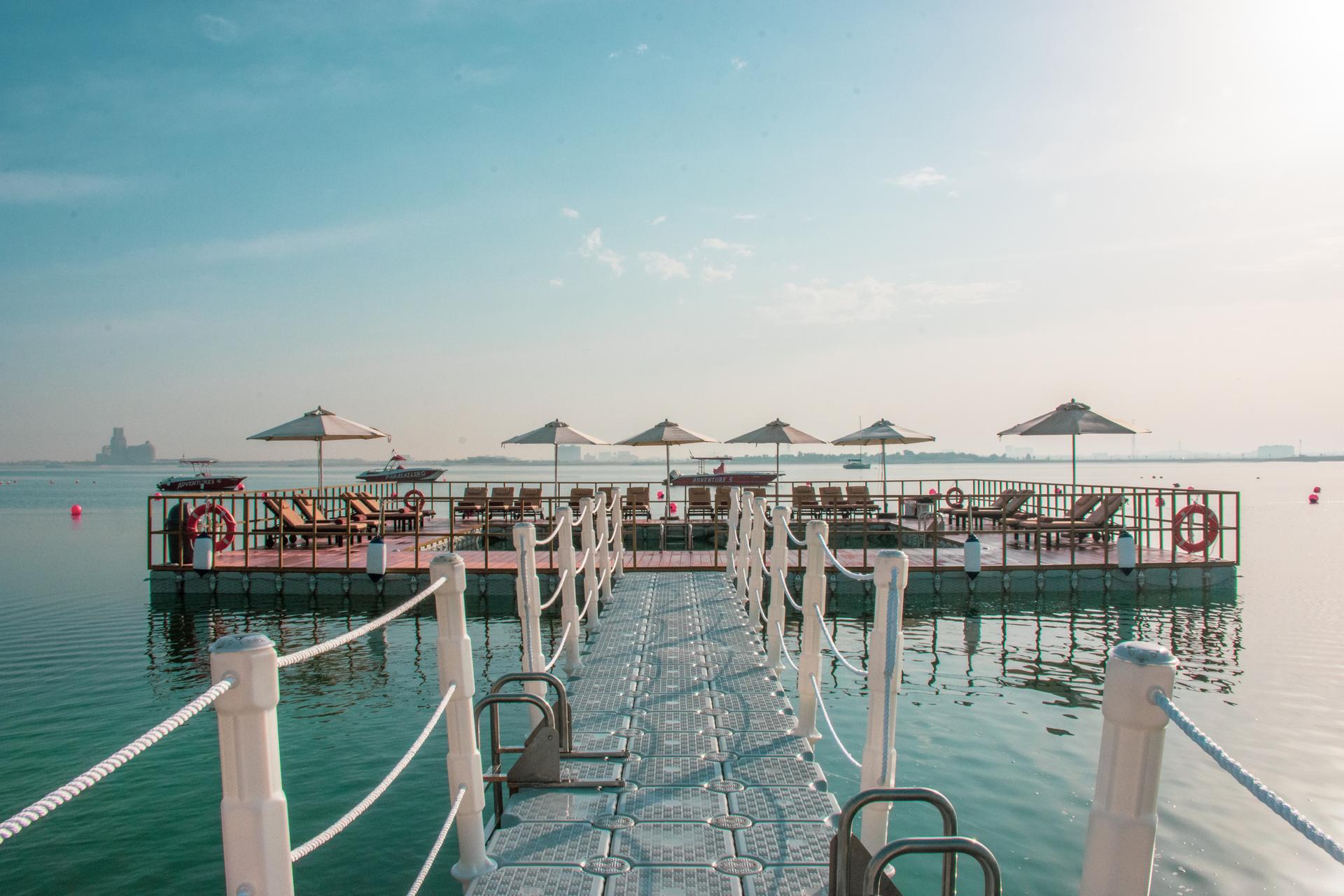Pier with sunbeds at the end overlooking the sea