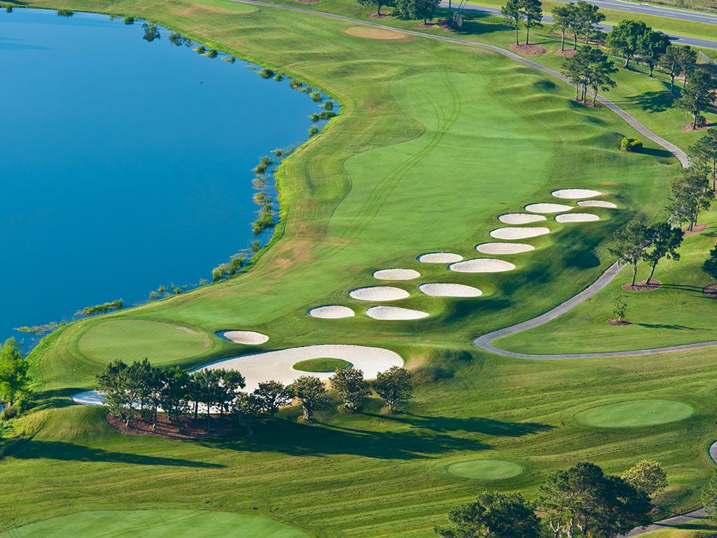 Aerial view of the manicured fairway with a large water hazard on one side