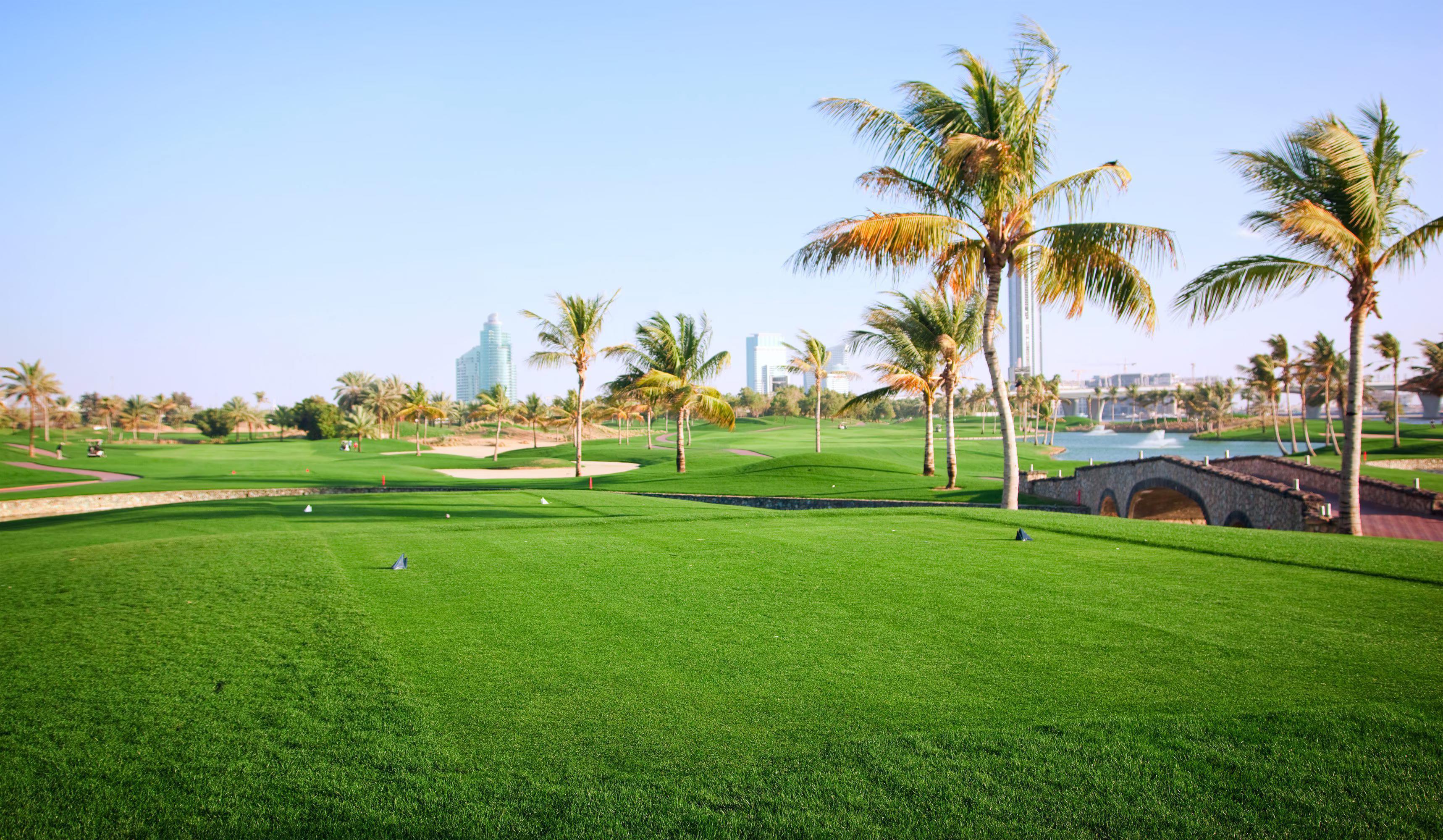 Well maintained fairways nestled with sand bunkers and palm trees