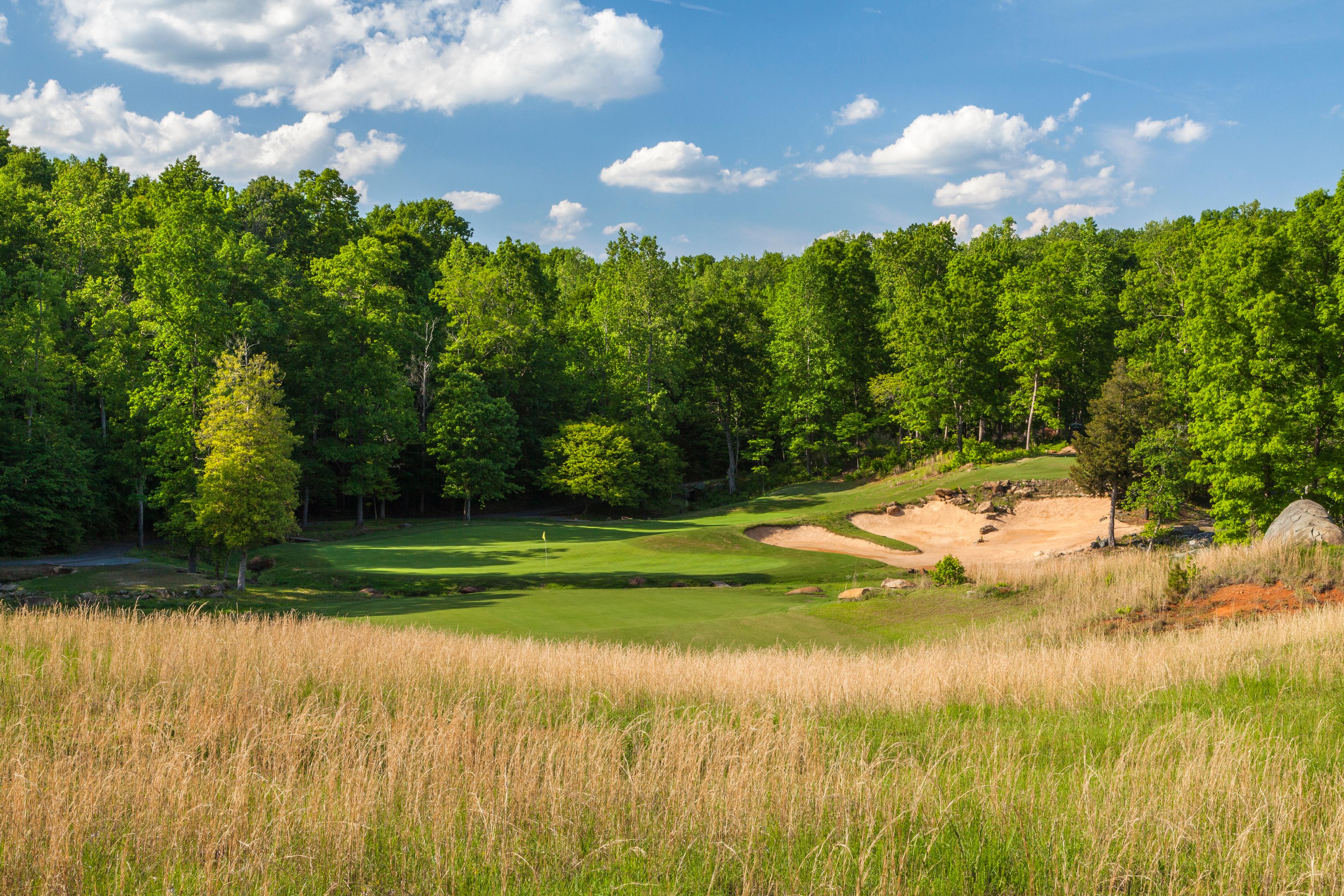 Overhead view of a well maintained course nestled with sand bunkers