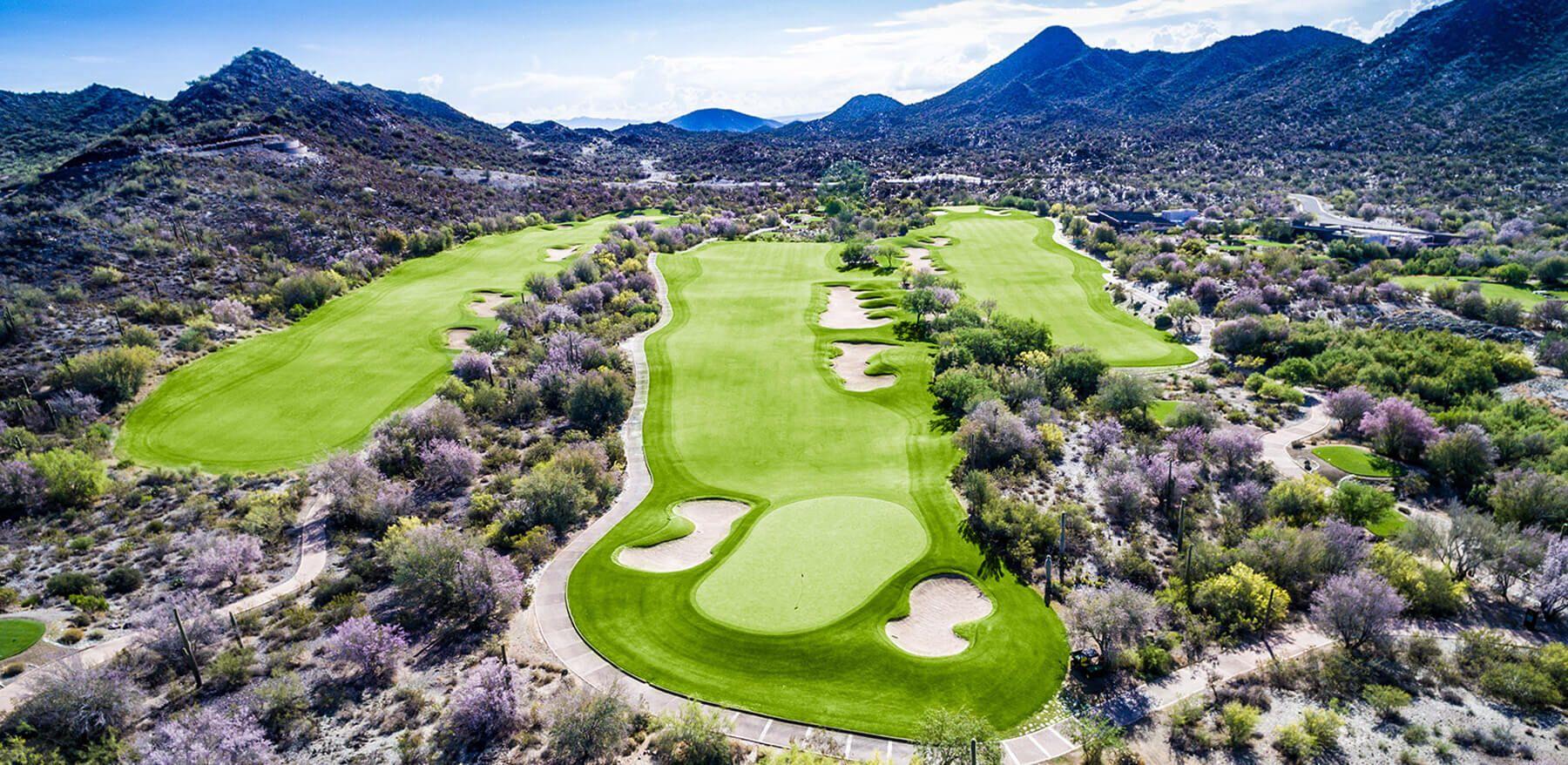 Manicured fairway leading to a smooth green sandwiched by sand bunkers