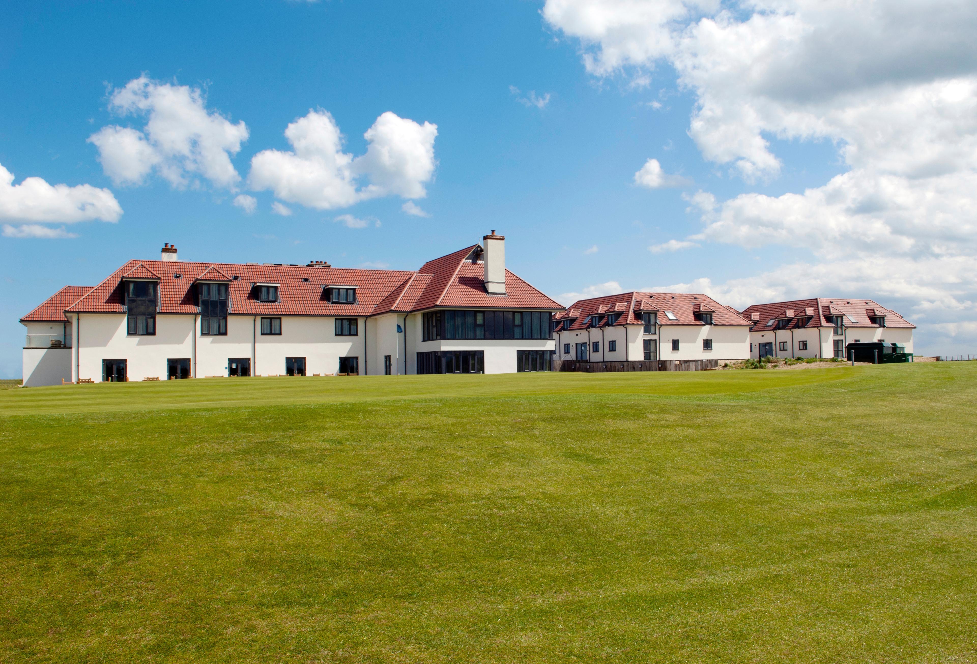 The Prince's clubhouse under blue skies looking out to the on sight course