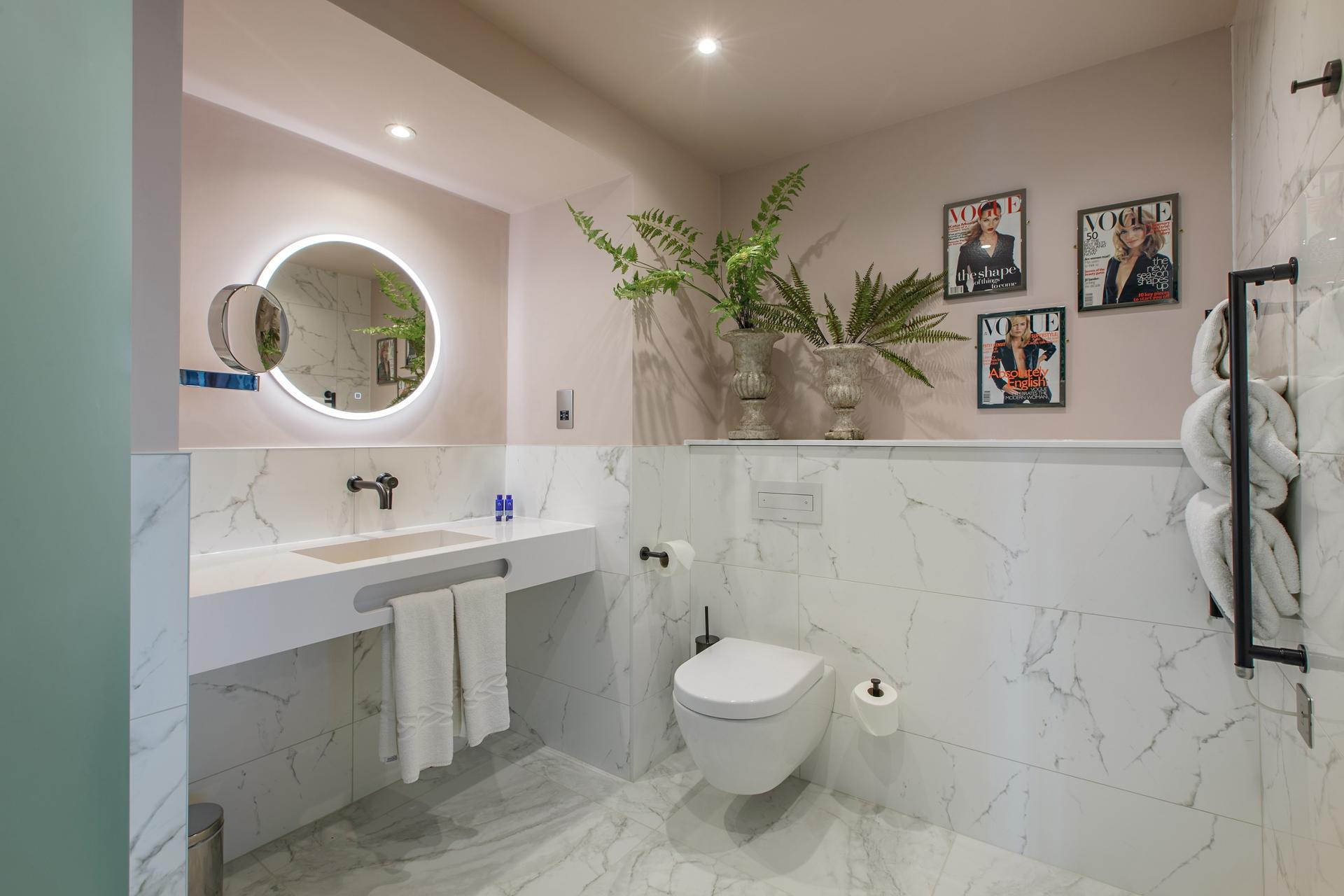 Modern bedroom with marble design and Vogue paintings on the wall