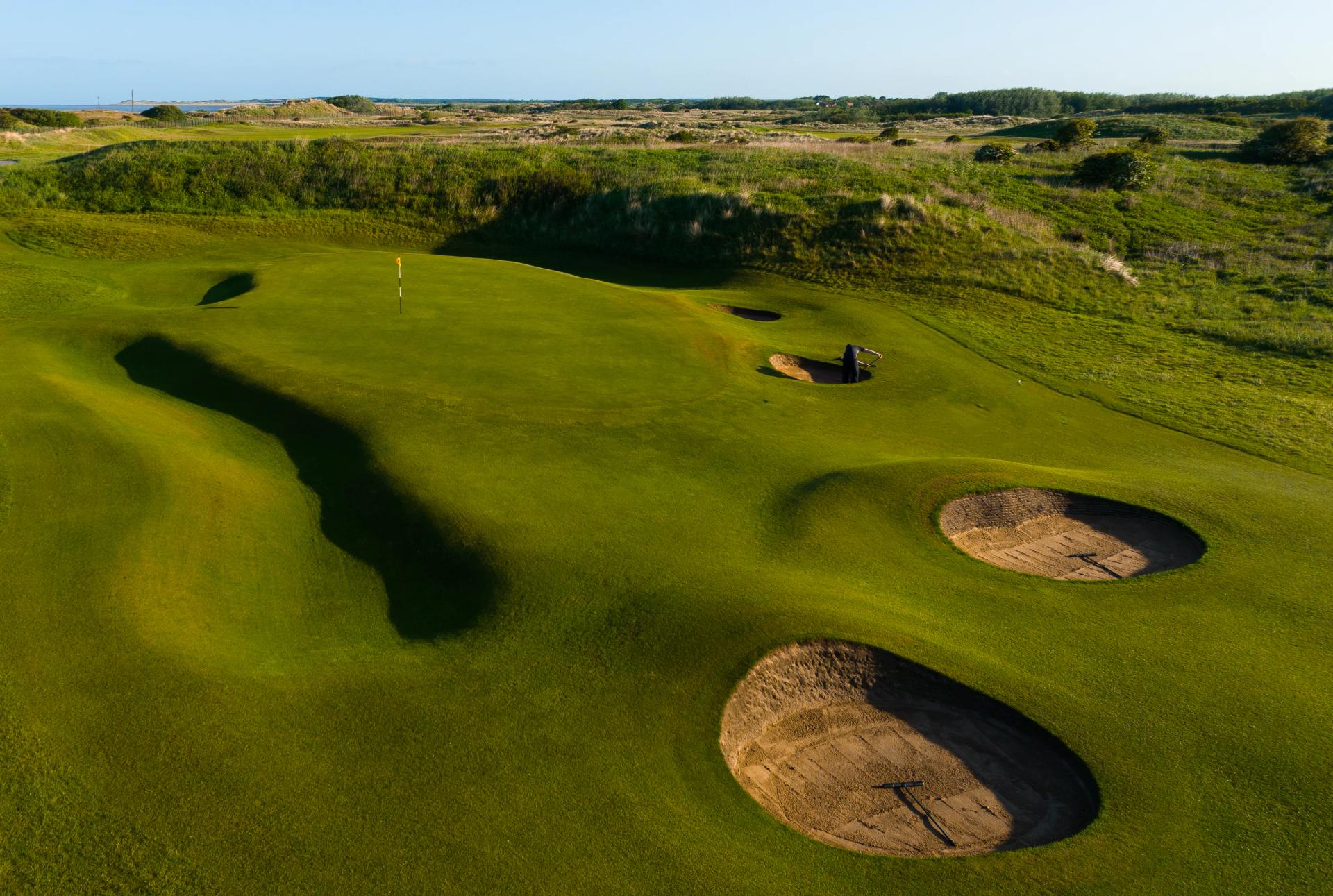 Overhead view of an elevated green surrounded by sand bunkers