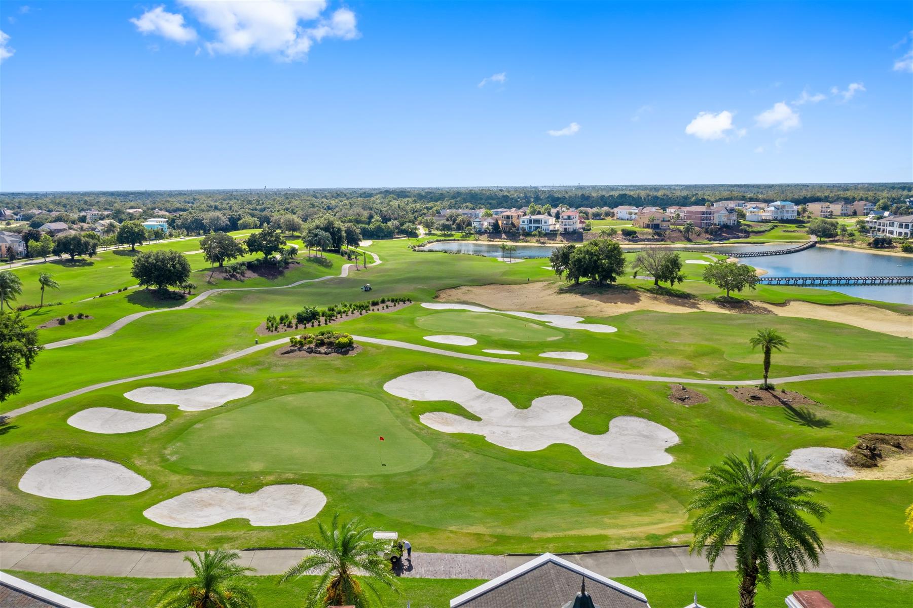 Overhead view of a smooth green surrounded by sand bunkers on the golf course at Encore Resort at Reunion
