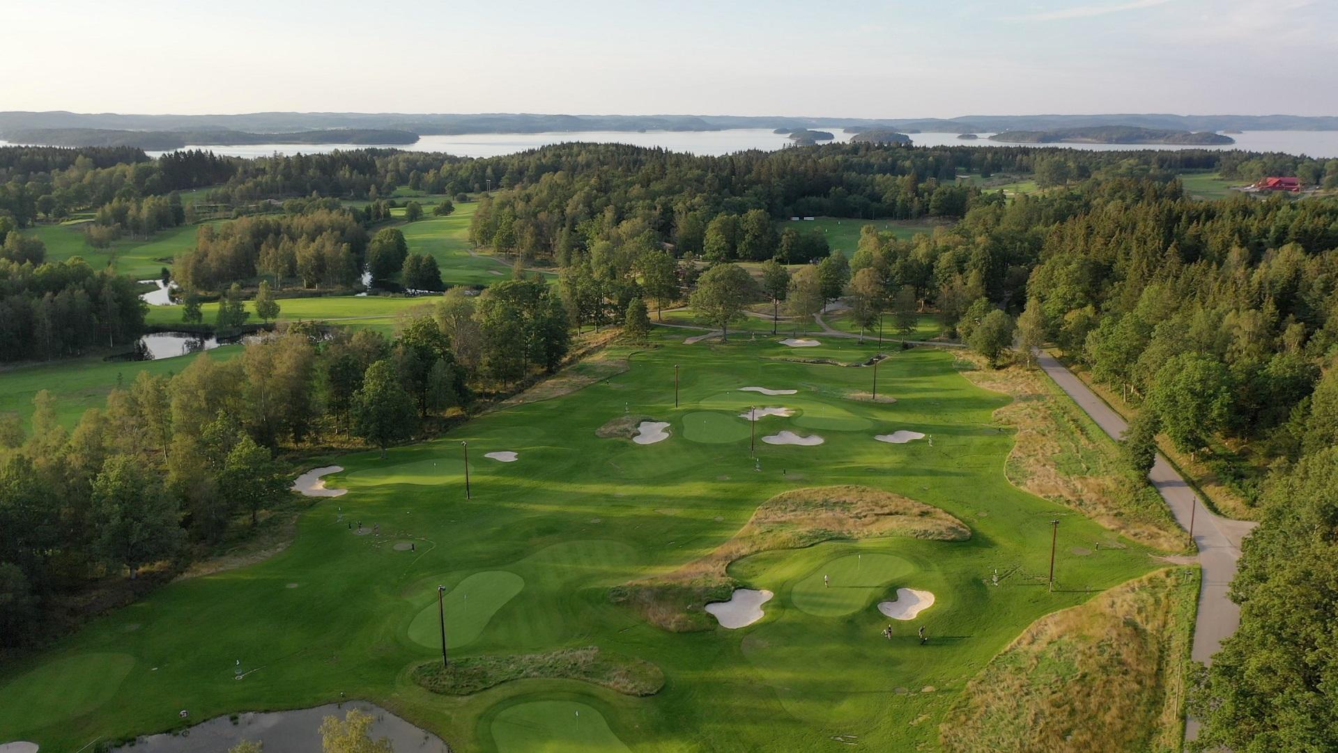 Overhead view of a manicured fairway nestled with sand bunkers