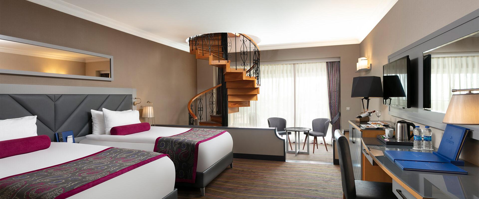 Twin double bed room with a winding staircase leading too a higher pool