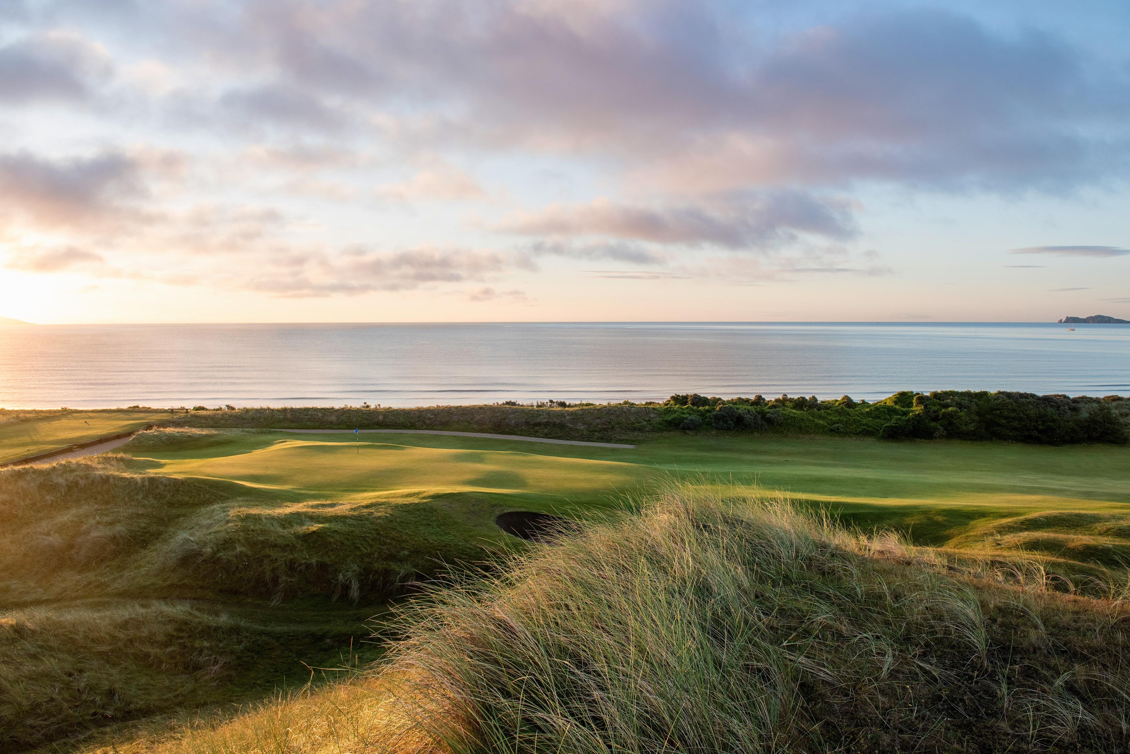 A coastal fairway nestled with sand bunkers surrounded by a mature rough