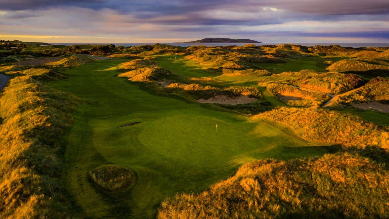 Overhead view of a manicured green surrounded by a mature rough