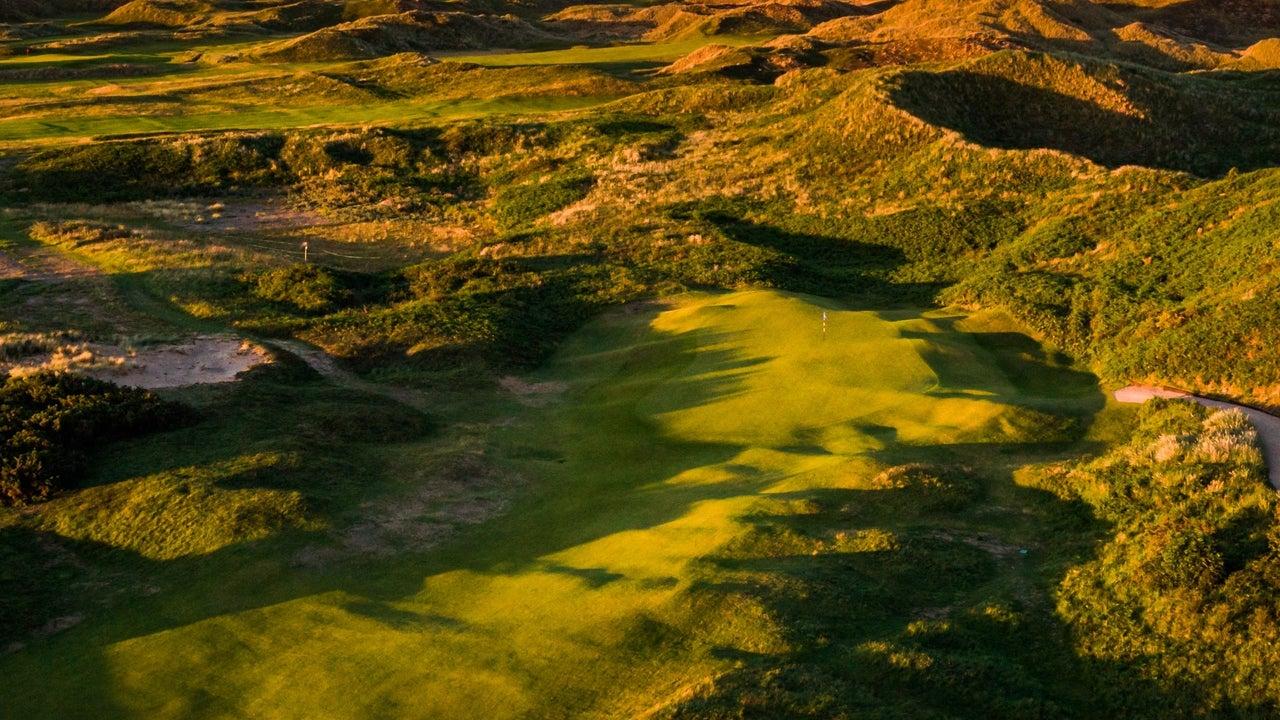 Overhead view of a winding fairway leading to a smooth green