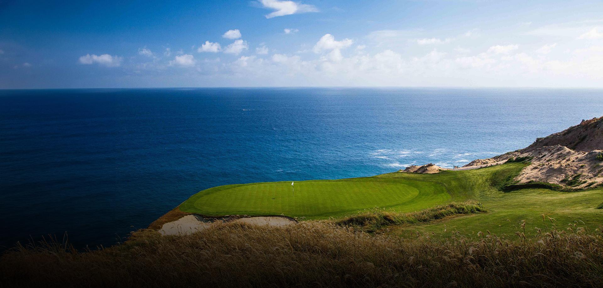 Panoramic view of a coastal green at Pueblo Bonito Pacifica Resort