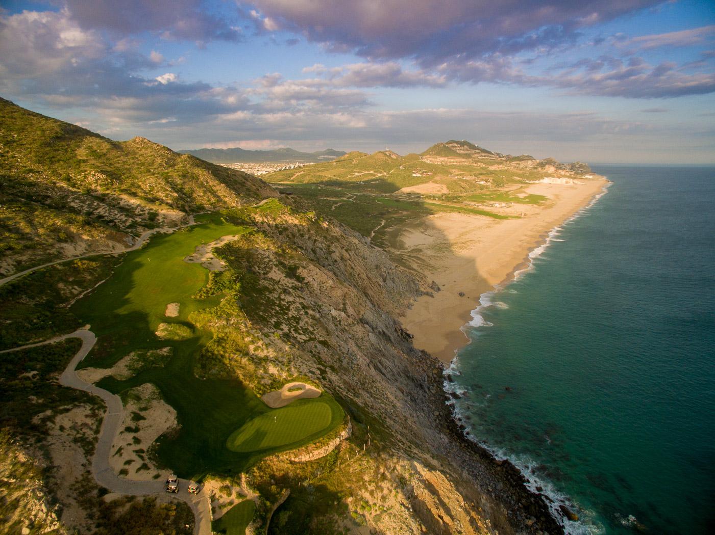 Overhead view of a cliffside green with coastal views