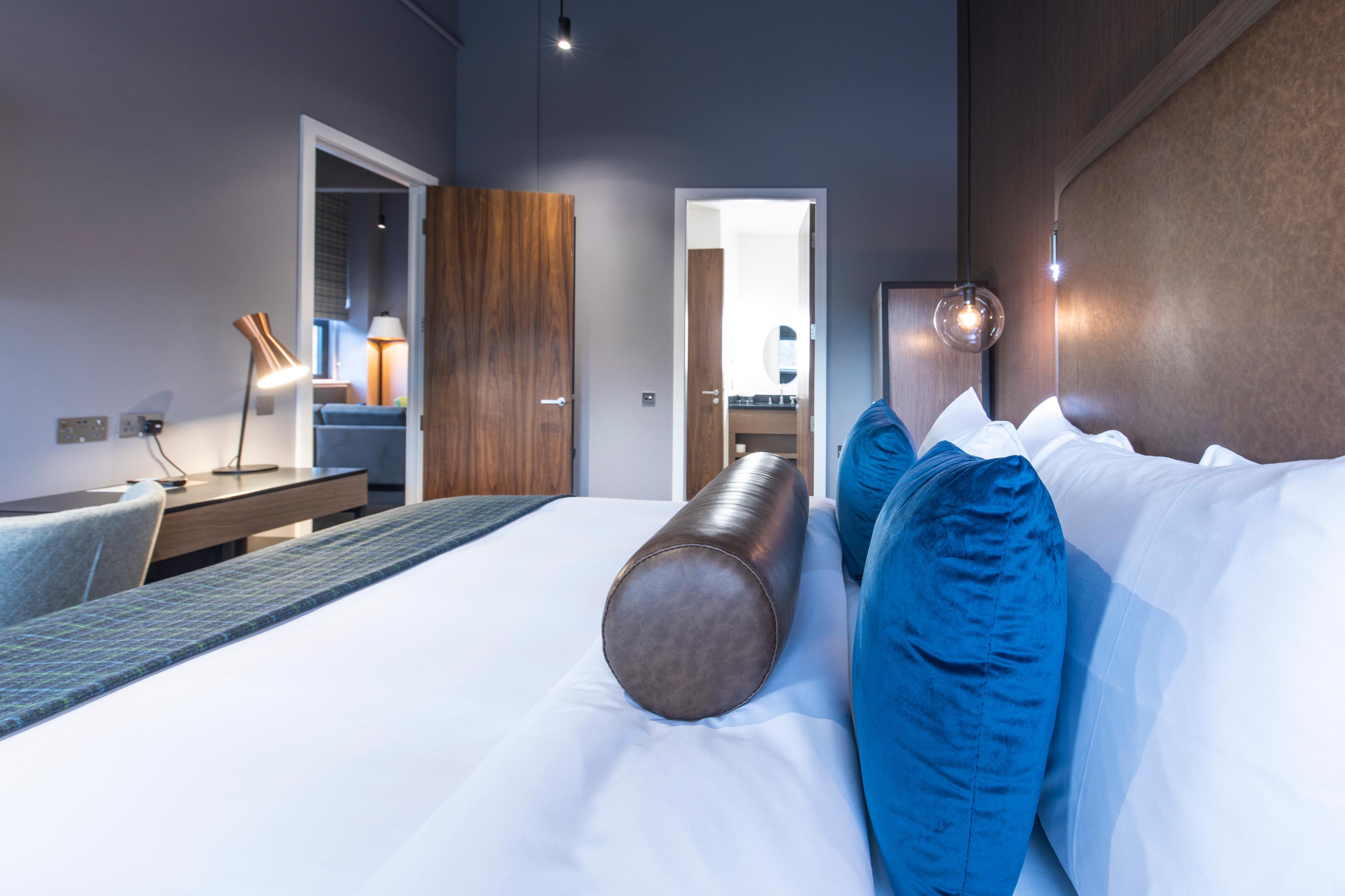 Bedroom as part of a suite at Sandman Signature Aberdeen Hotel