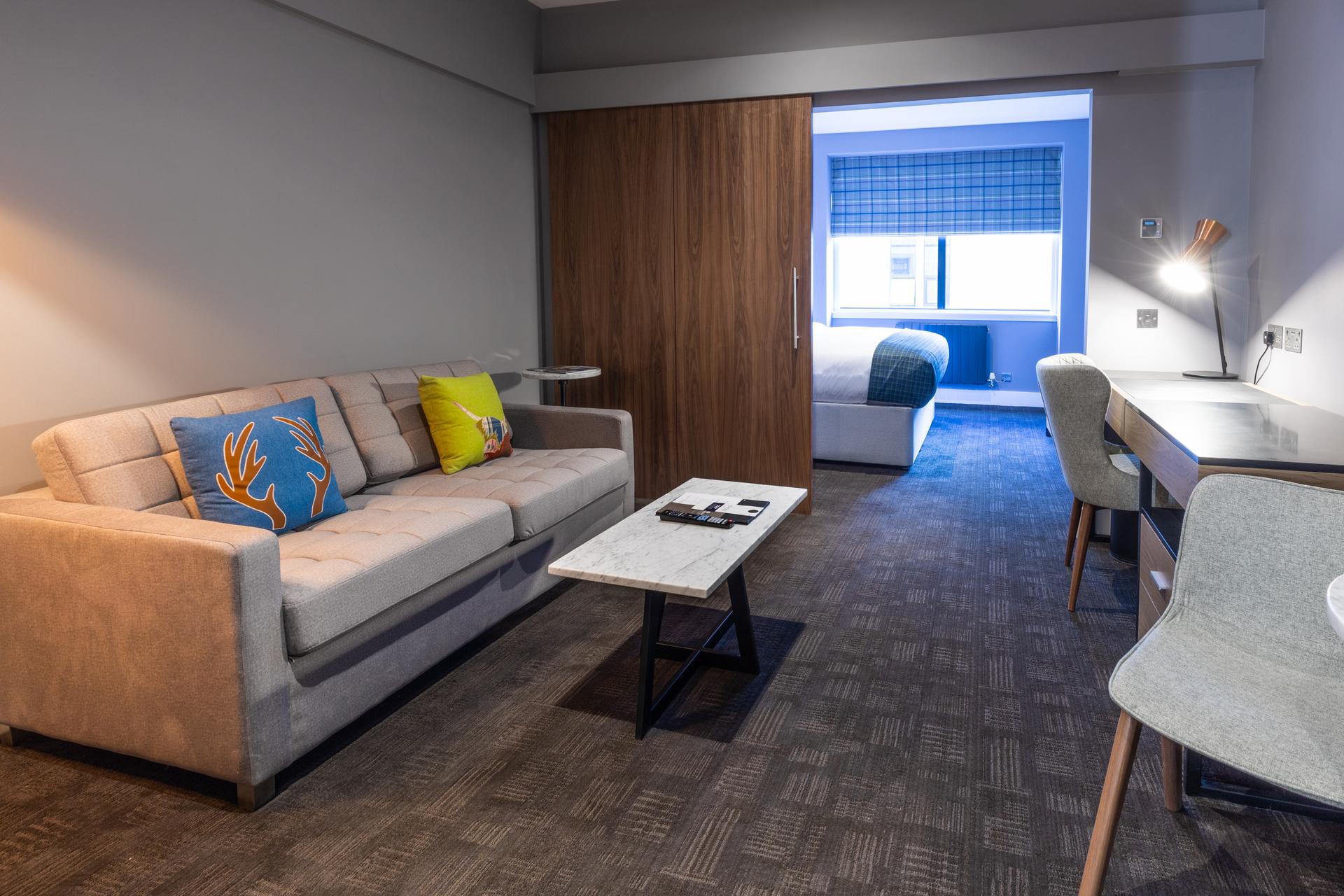 Double bed suite with separate living room at Sandman Signature Aberdeen Hotel