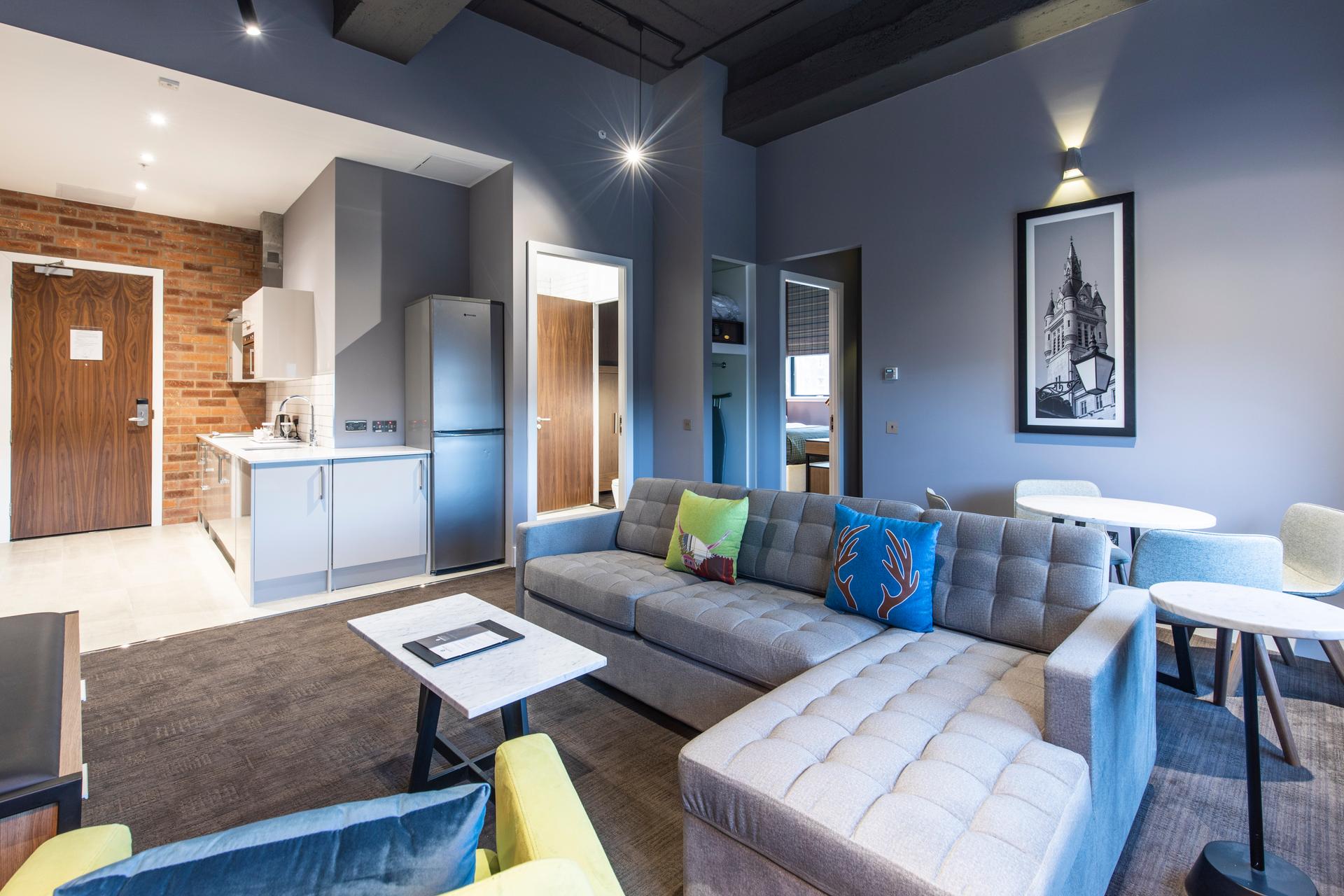 Living room and kitchen as part of a double bed suite at Sandman Signature Aberdeen Hotel