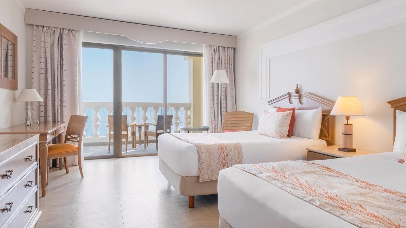 Twin bed suite with balcony views at Iberostar Waves Rose Hall Beach