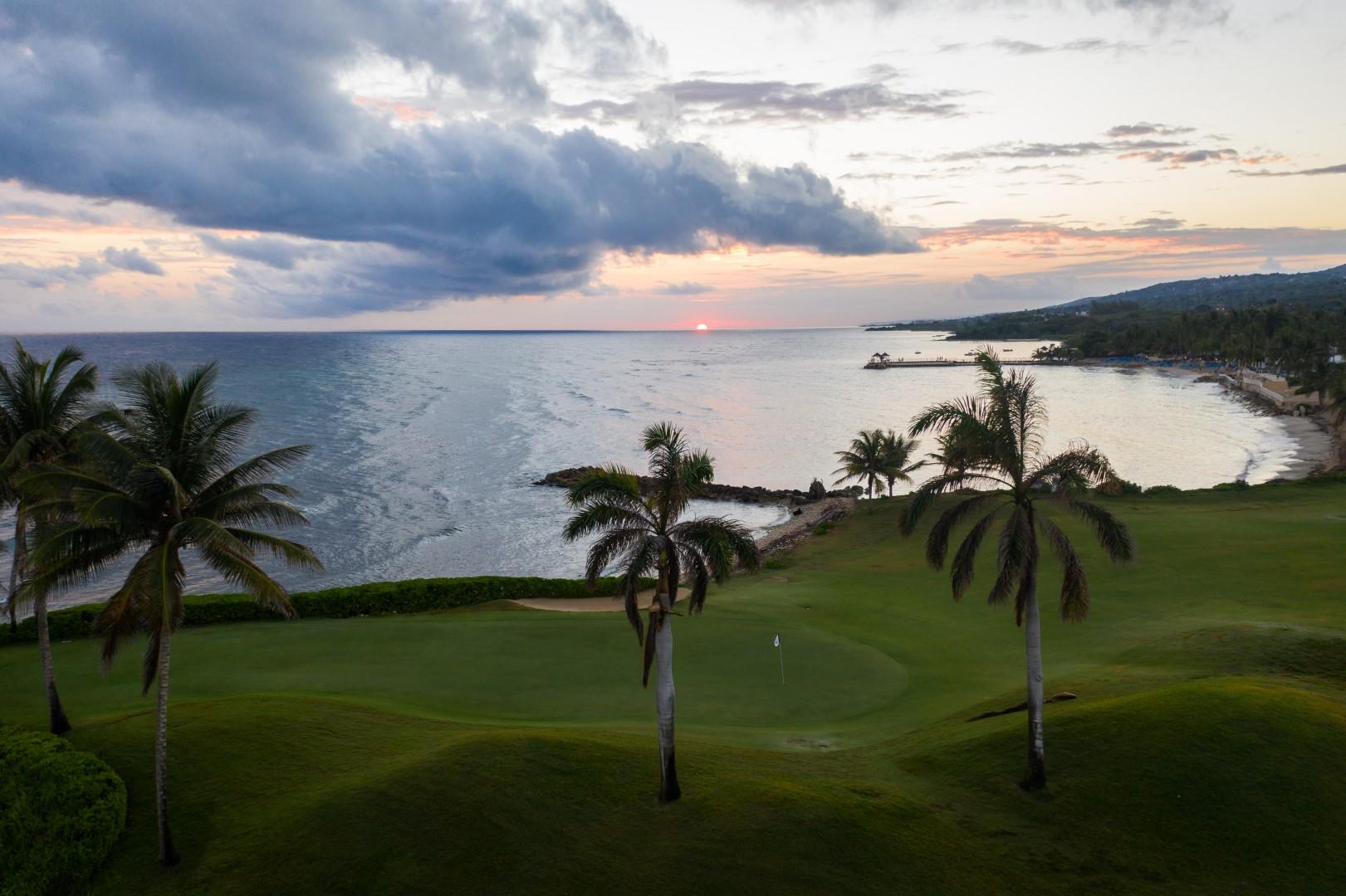 A smooth coastal green with ocean views at Iberostar Waves Rose Hall Beach