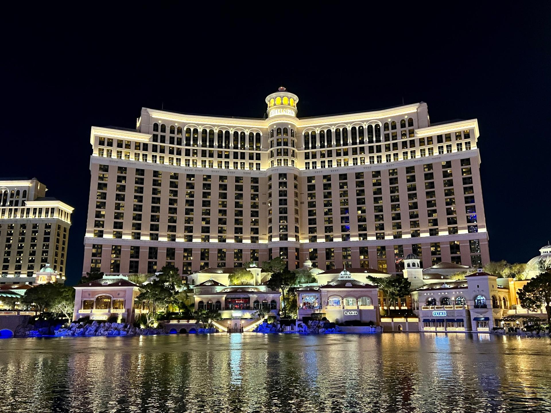 Night view of the illuminated Bellagio Hotel reflecting on the water.
