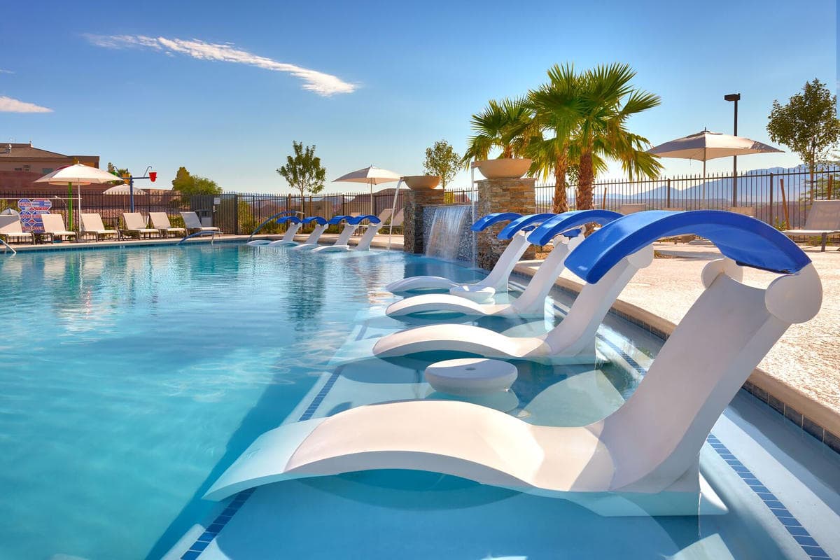 Sunbeds inside the outdoor swimming pool for guests to lounge in
