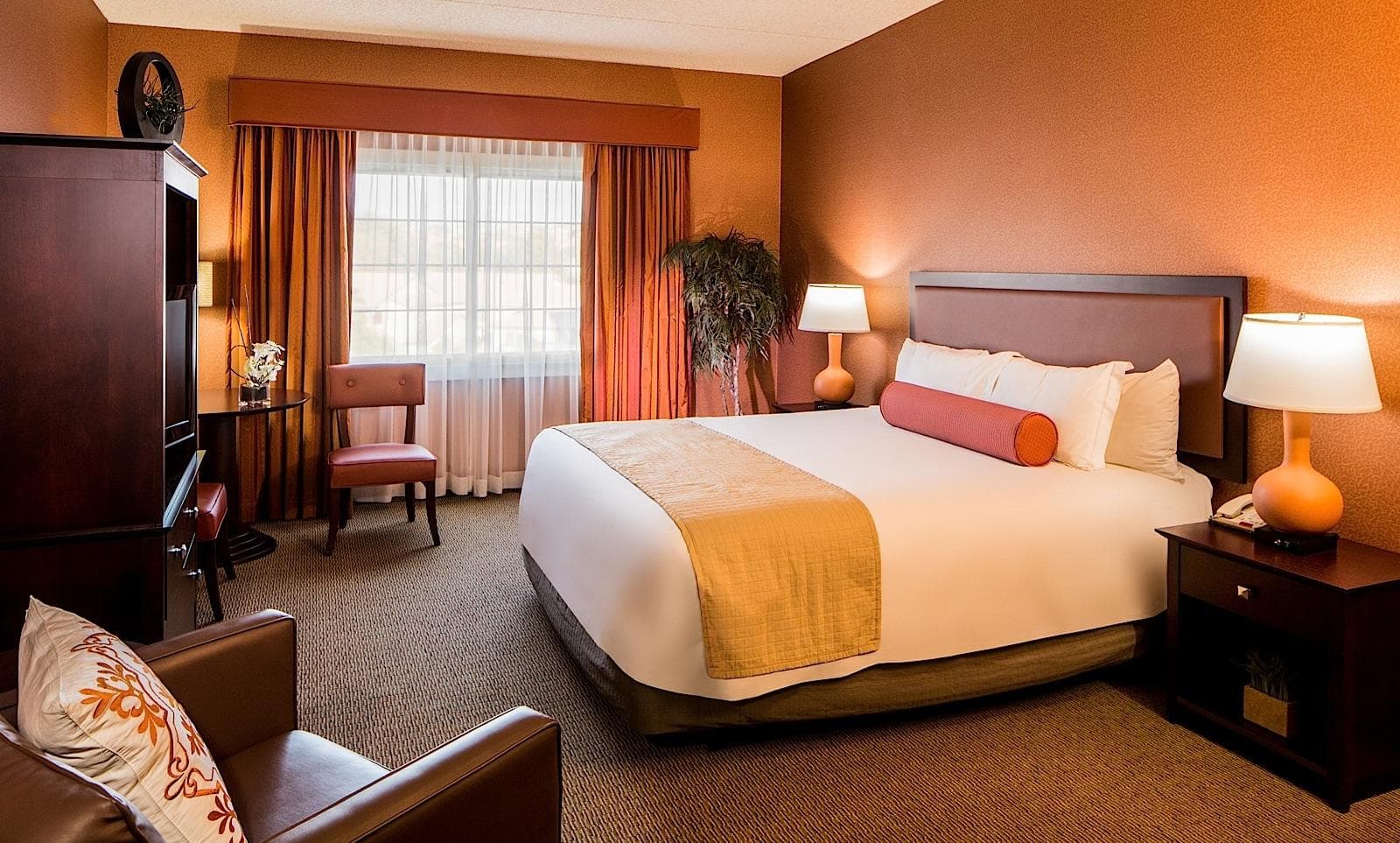 Double bed room with seating area and television