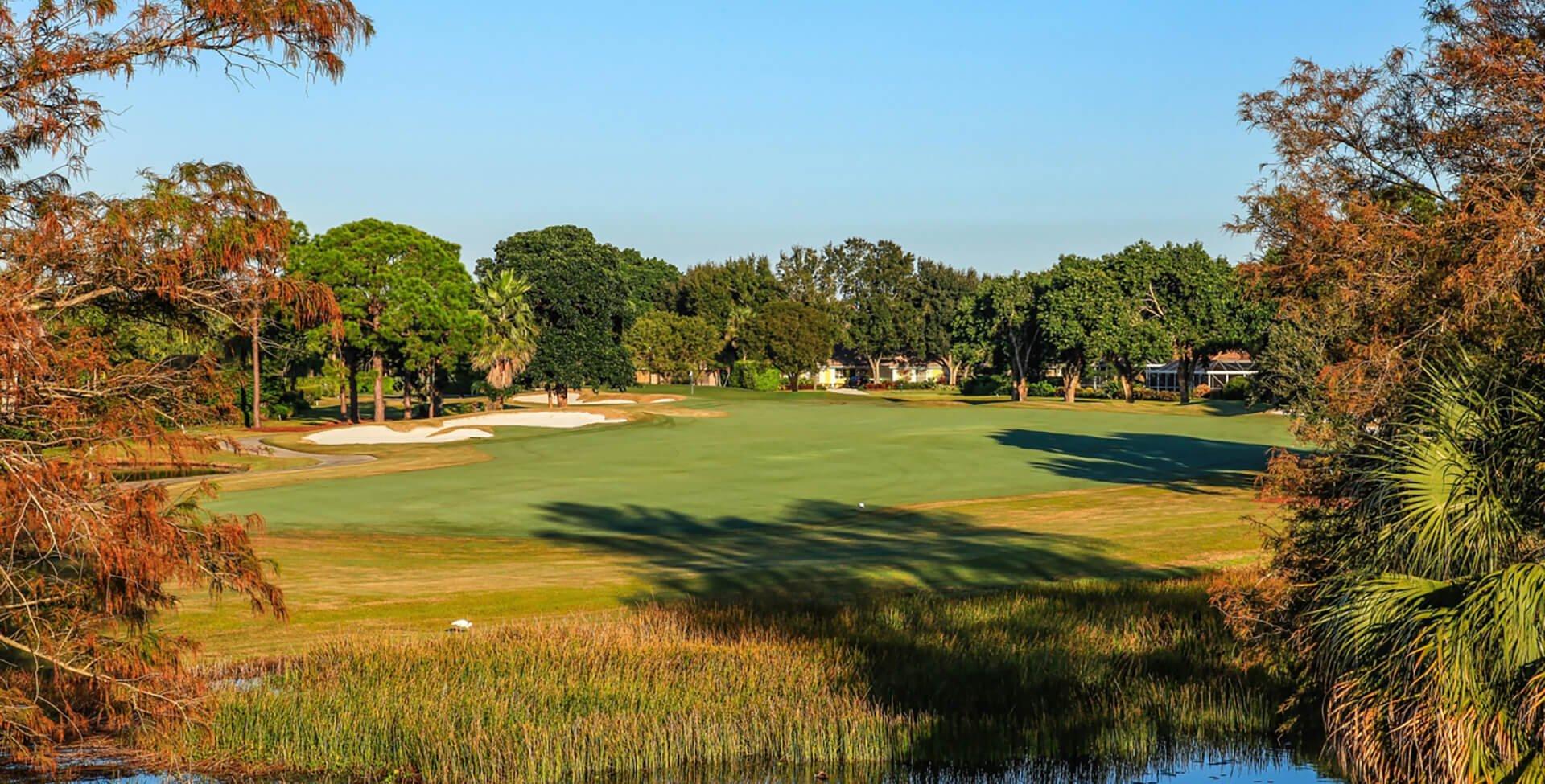 Wide fairway surrounded by a yellow rough and sand bunkers